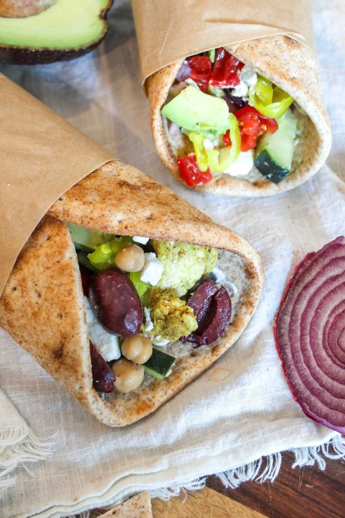 two easy chicken pita wraps on a white napkin.