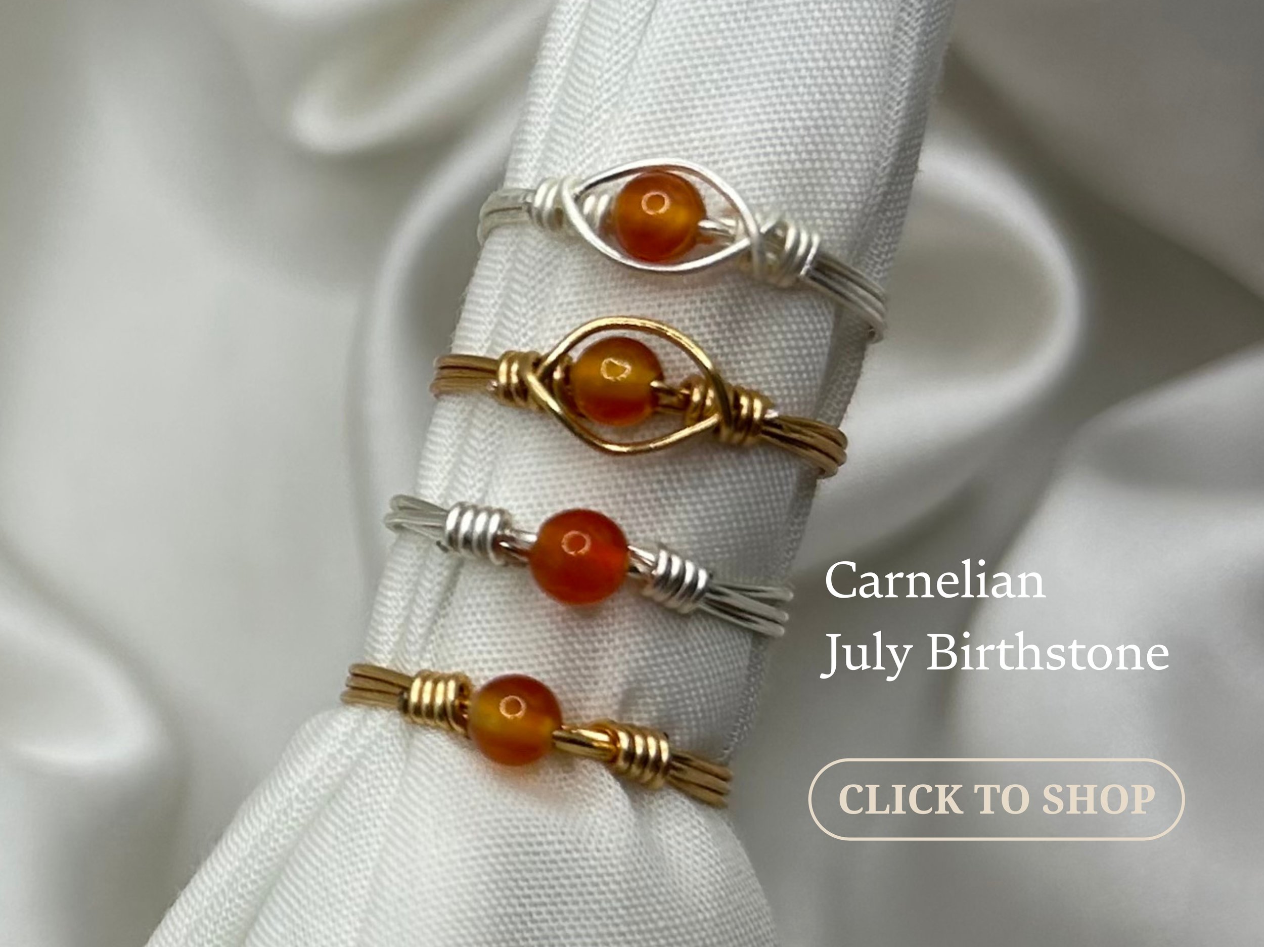 Four wire-wrapped rings with carnelian birthstones, each in silver or gold tones, displayed on a white fabric background with text indicating they are July birthstone jewelry.