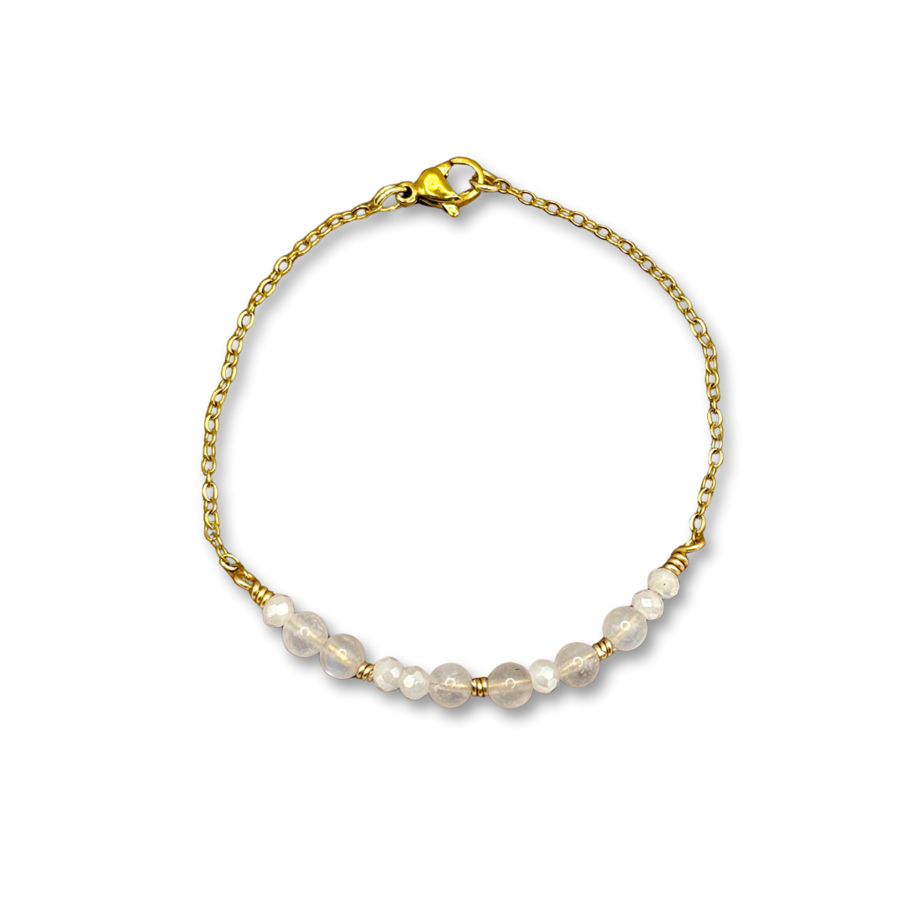 Two beaded bracelets on wrist, gold and one silver, with amber beads.