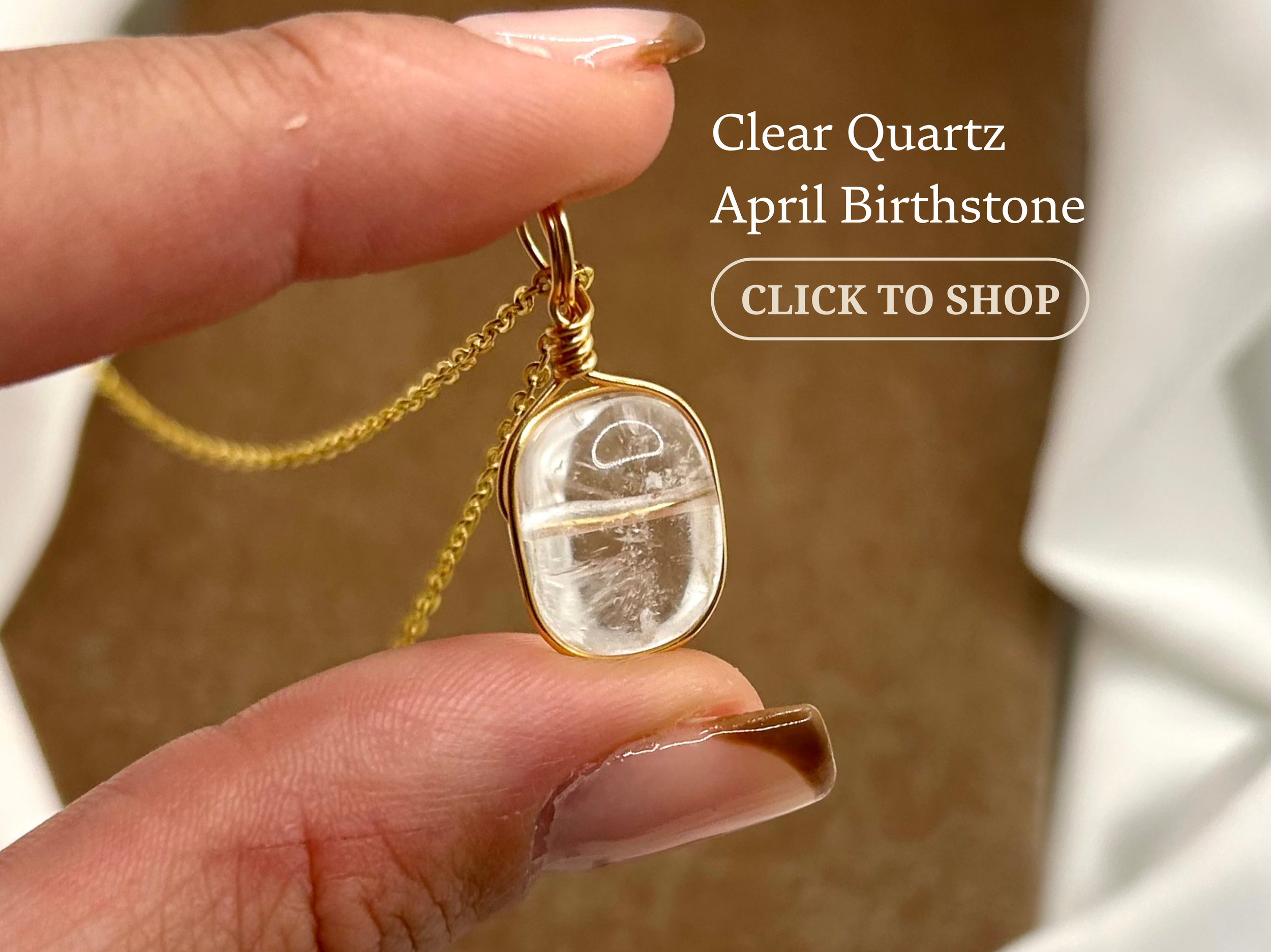 Close-up of a hand holding a gold necklace with a clear quartz pendant shaped like a capsule, with text overlay advertising the quartz as 'April Birthstone' and a clickable shop button.