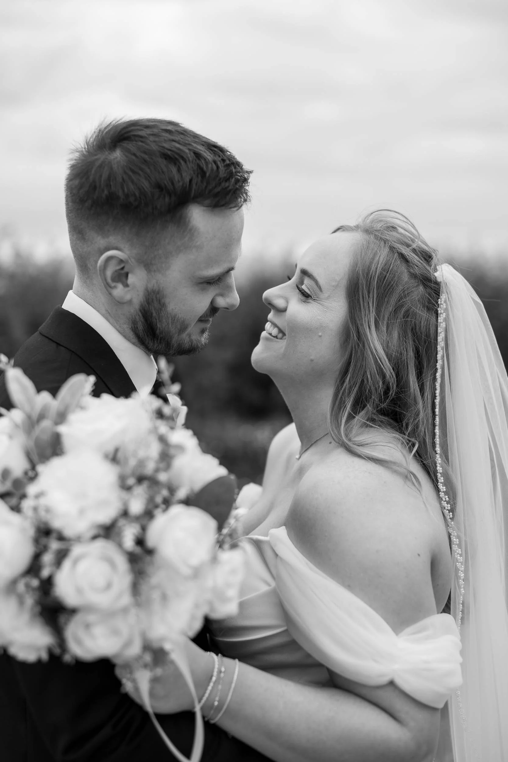 Bride and Groom facing each other and smiling