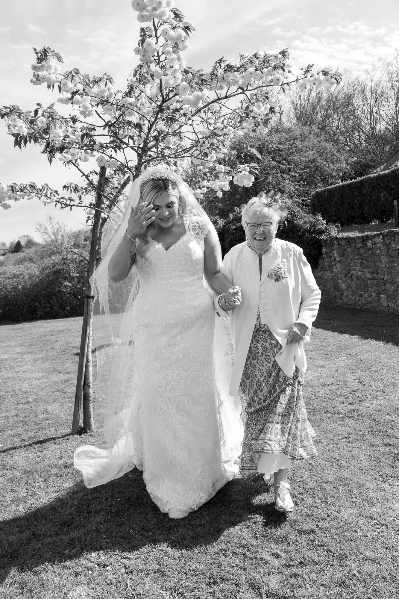 bride walking with grandmother. The Orchard, Kent.