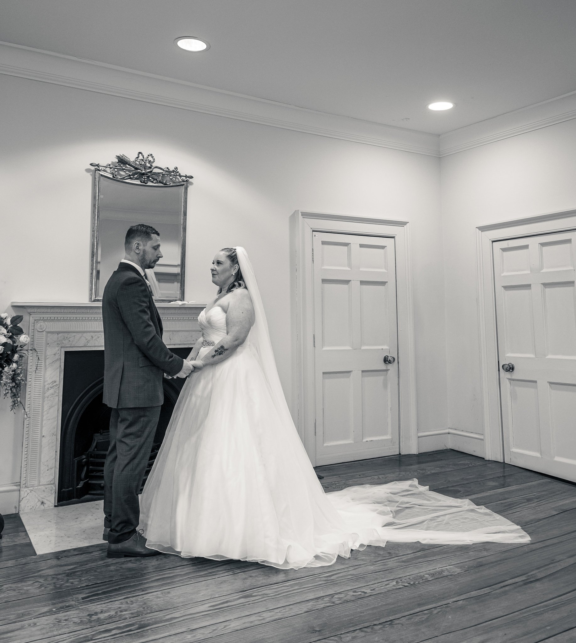 Bride and groom holding hands during ceremony. Danson House, Kent.