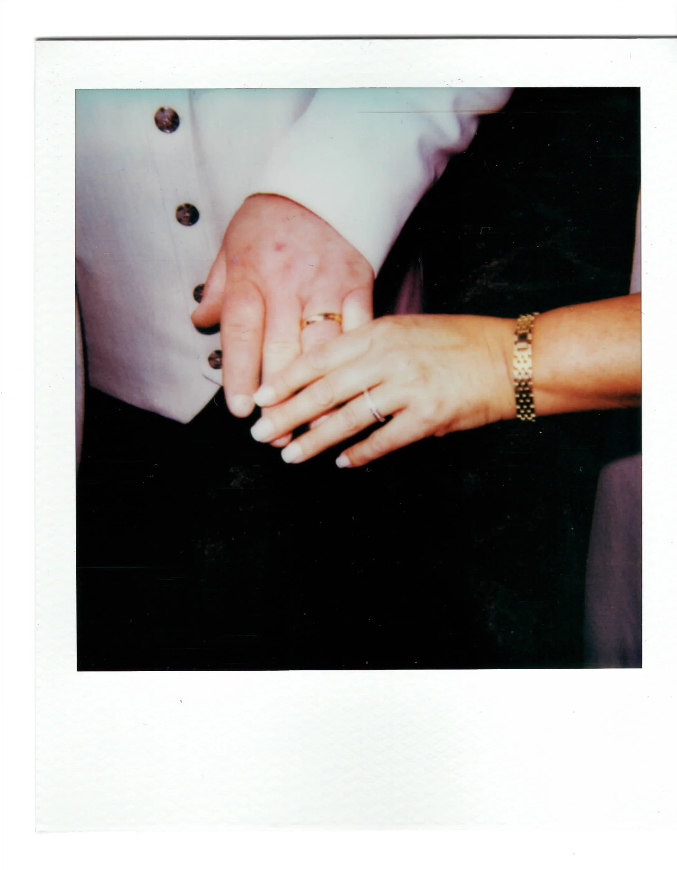 Polaroid of bride and grooms rings