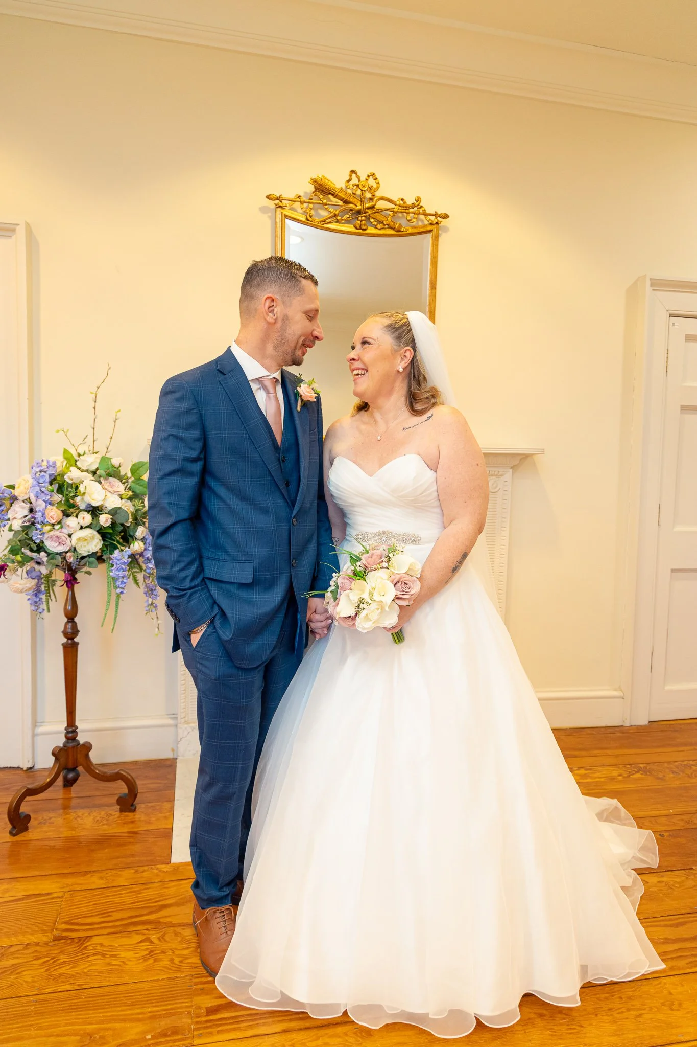 Bride and Groom smiling at each other. Danson House, Kent.