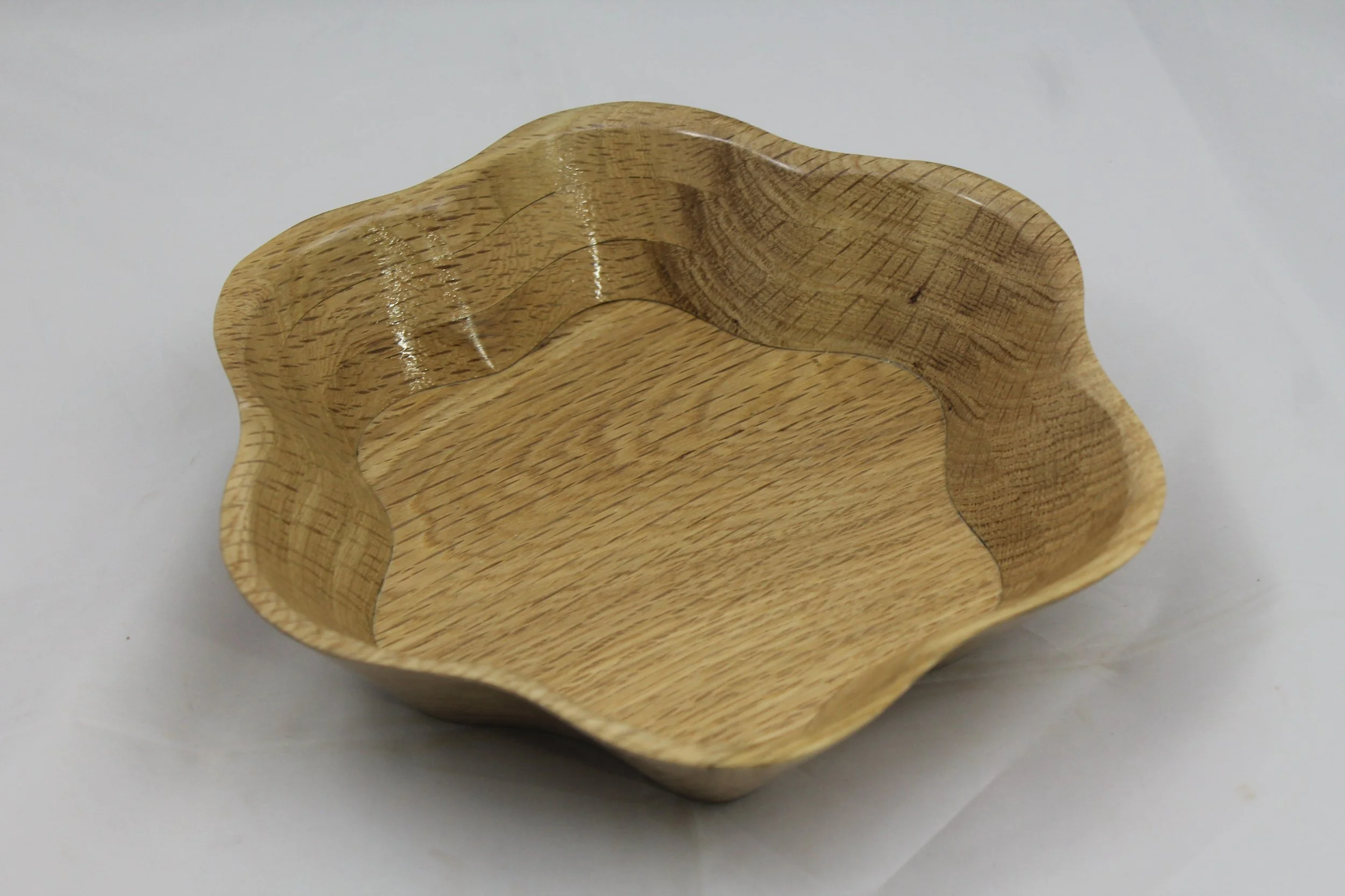 6248 - White Oak 6 pedal bowl.
This bowl is made with the scroll saw.  The design lets you use this bowl for different purposes. 
It is 9”  in diameter and 2” high.
$ 55