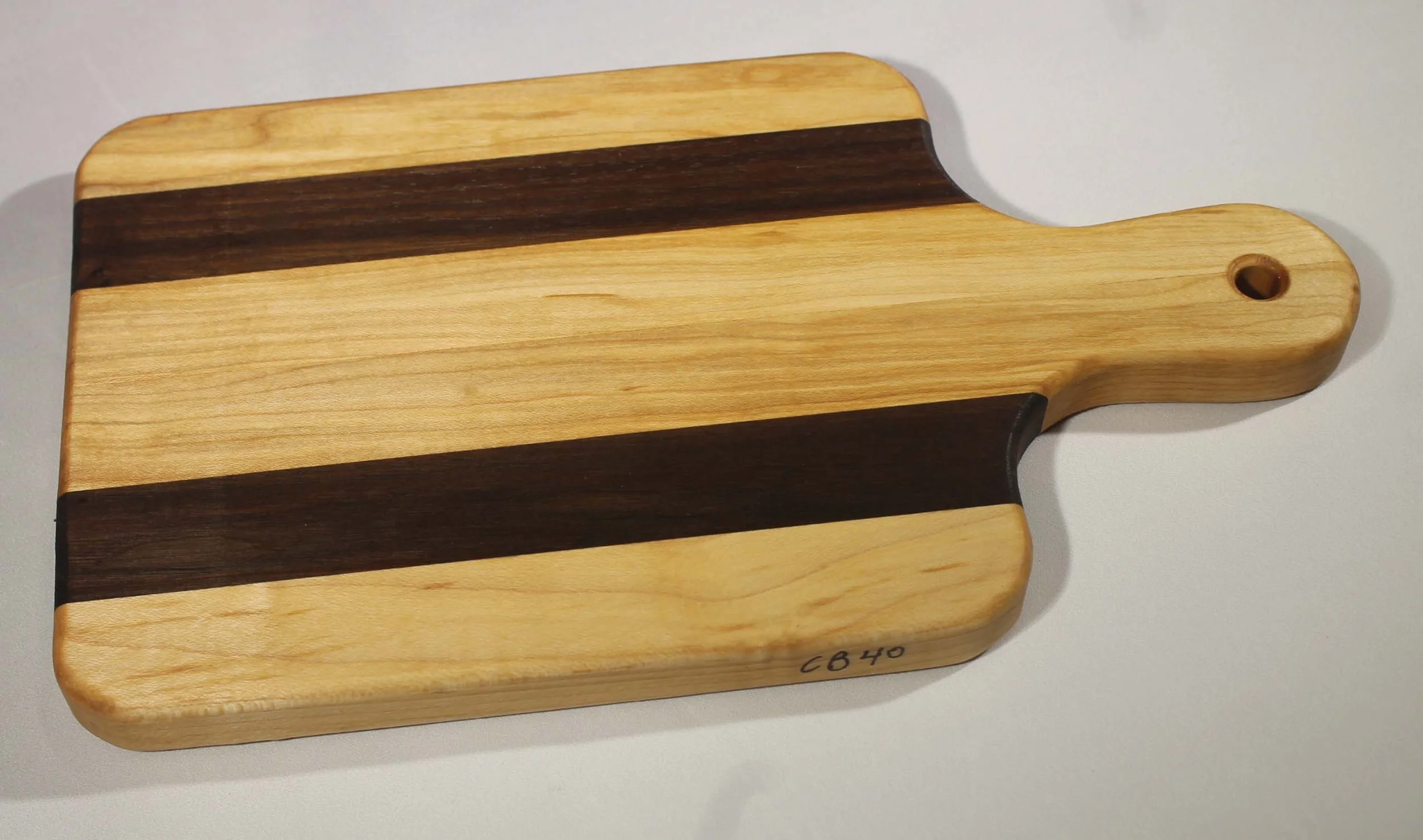 CB 37 - 6” x 10 ¾” Cutting board with handle.
$35