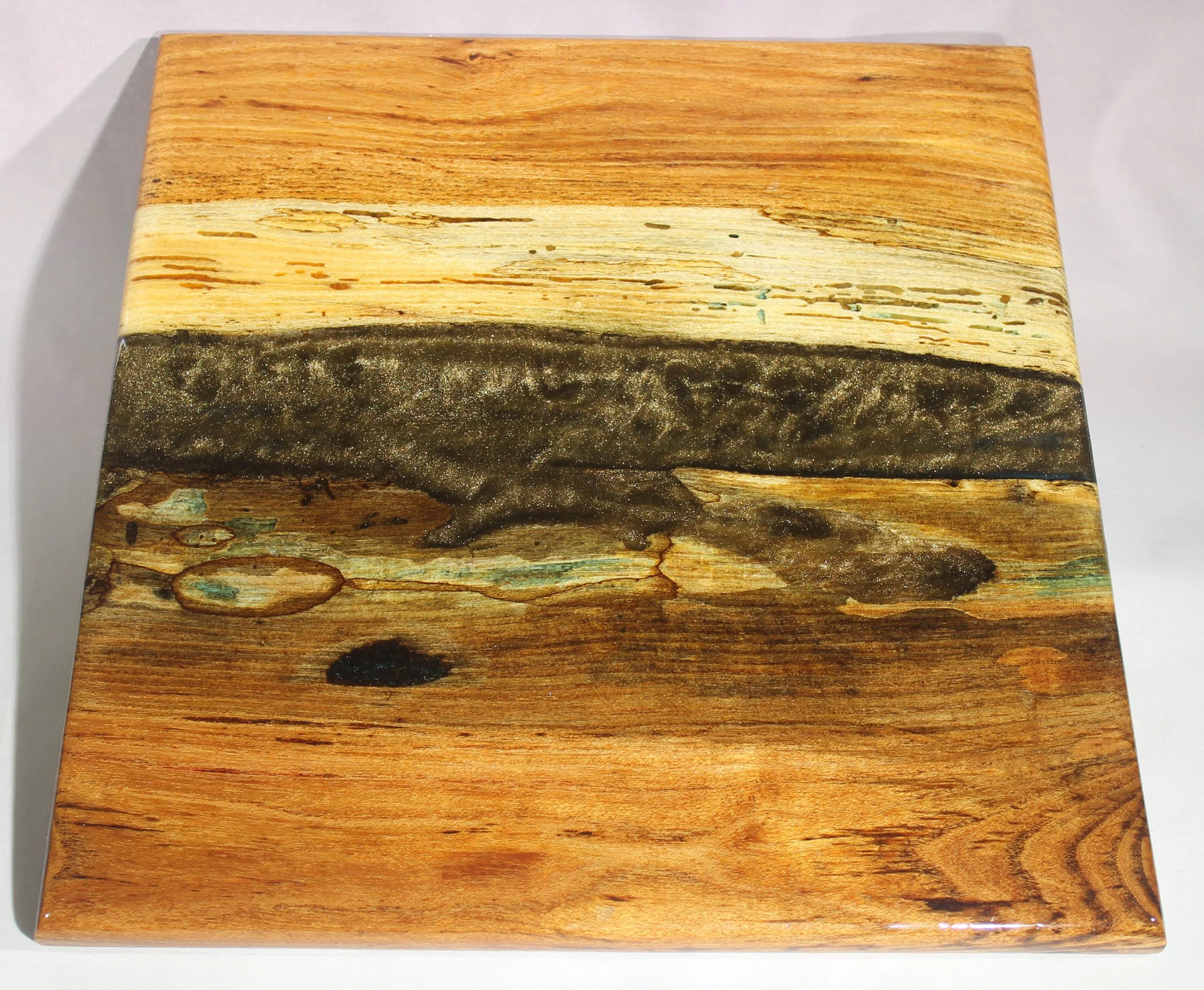 CB64  -  Charcuterie & Cheese Board

$200

This is a honey locust wood with black resin and gold mica powder 
It has several coats of epoxy to give it a high gloss finish and is food safe.

This board is for serving cheese or other appetizers.  

It 