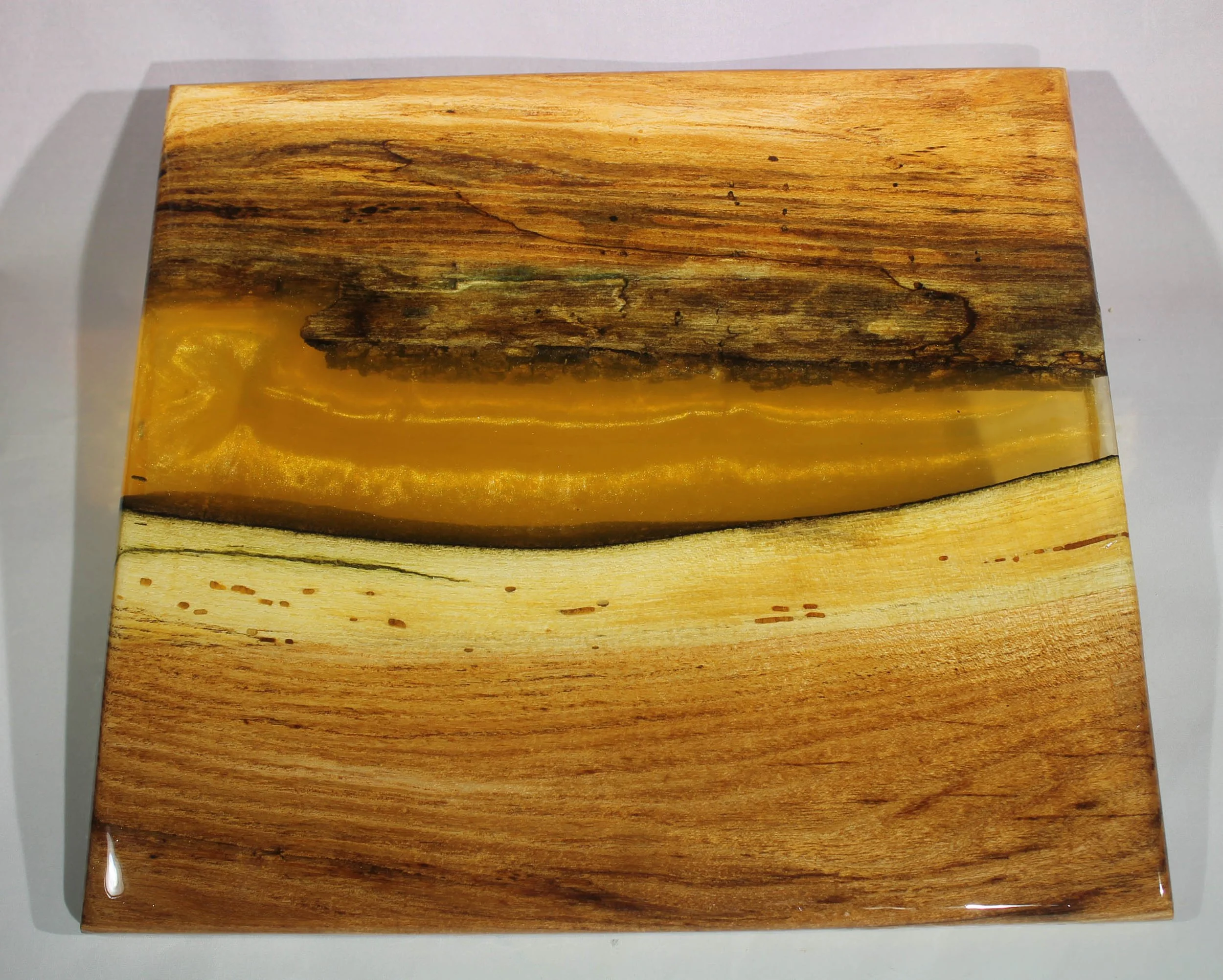 CB61  - Charcuterie & Cheese Board

$200

This is a honey locust wood with blue resin and silver mica powder 
It has several coats of  epoxy to give it a high gloss finish and is food safe.

This board is for serving cheese or other appetizers.  

It