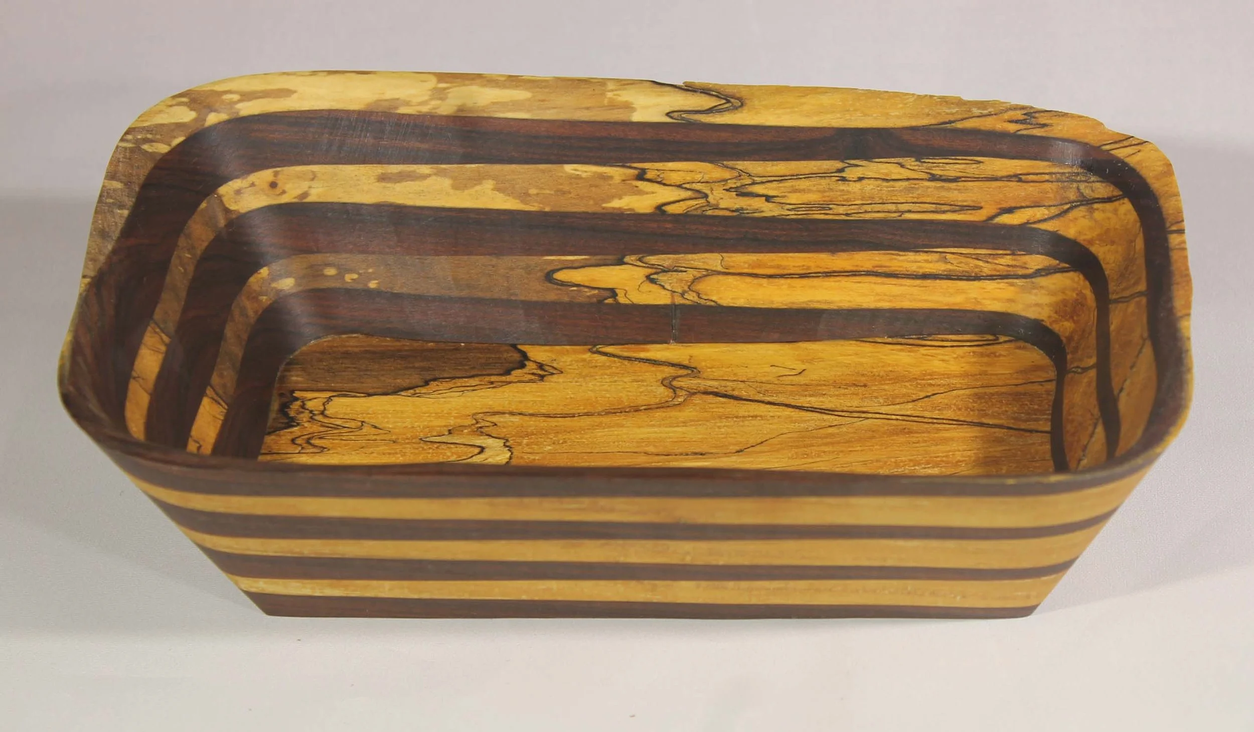 #6340  -  Pecan / Walnut rectangular wedge bowl.  
This is my signature wedge design with Pecan wood and Walnut.     The color and texture of this bowl is fantastic.  The irregular edges are from the spalting of the Pecan.  Spalting is  a natural pro