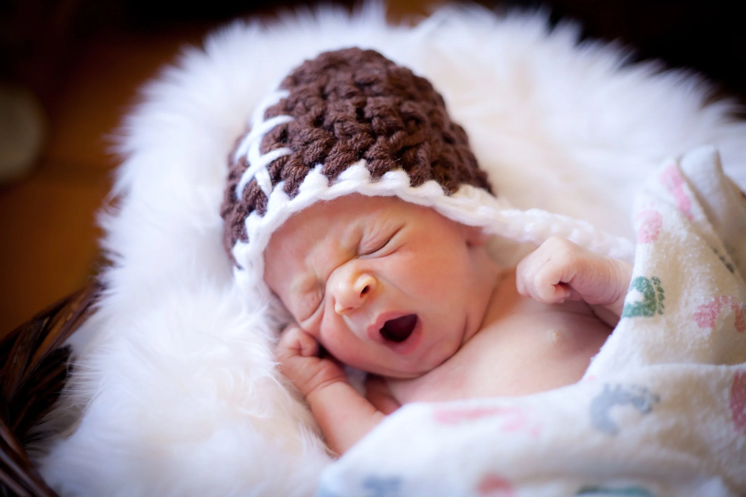 Newborn baby yawning being relaxed after his first pediatric chiropractic adjustment at The Chiropractic Place for Mommy and Me in Aledo, Texas