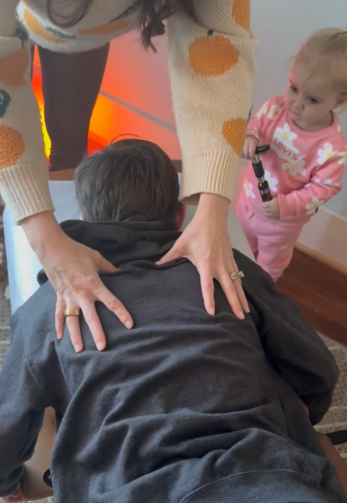 Teenager getting pediatric chiropractic adjustment with younger sister watching him at The Chiropractic Place for Mommy and Me in Aledo, Texas
