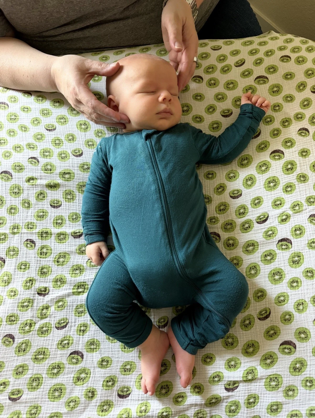 Infant doing a full craniosacral therapy session with Rachel Gabsi, LMT, at The Chiropractic Place for Mommy & Me in Aledo, Texas