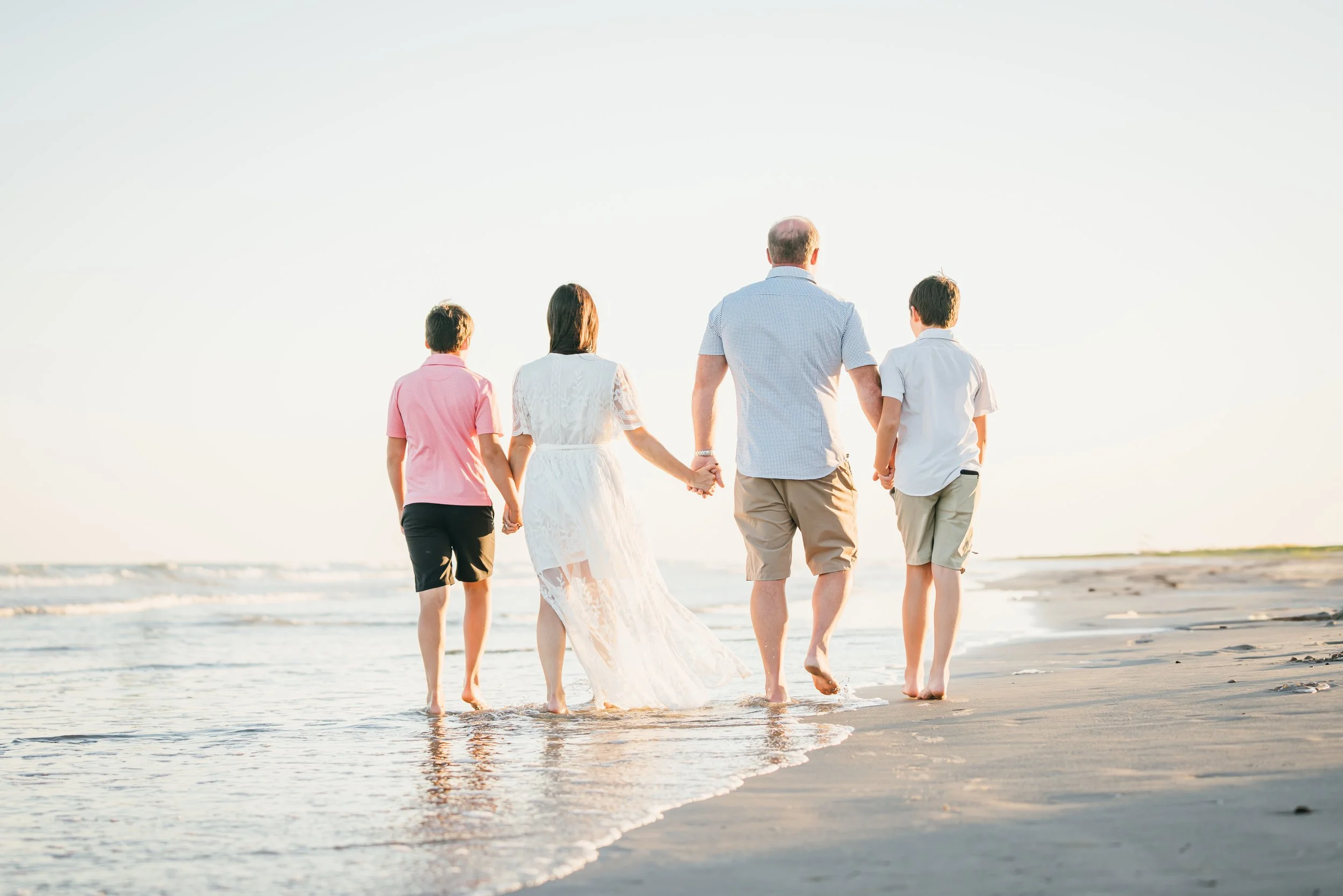 Peaceful picture of Dr Parker and her family walking on the beach in Texas experiencing nervous system regulation