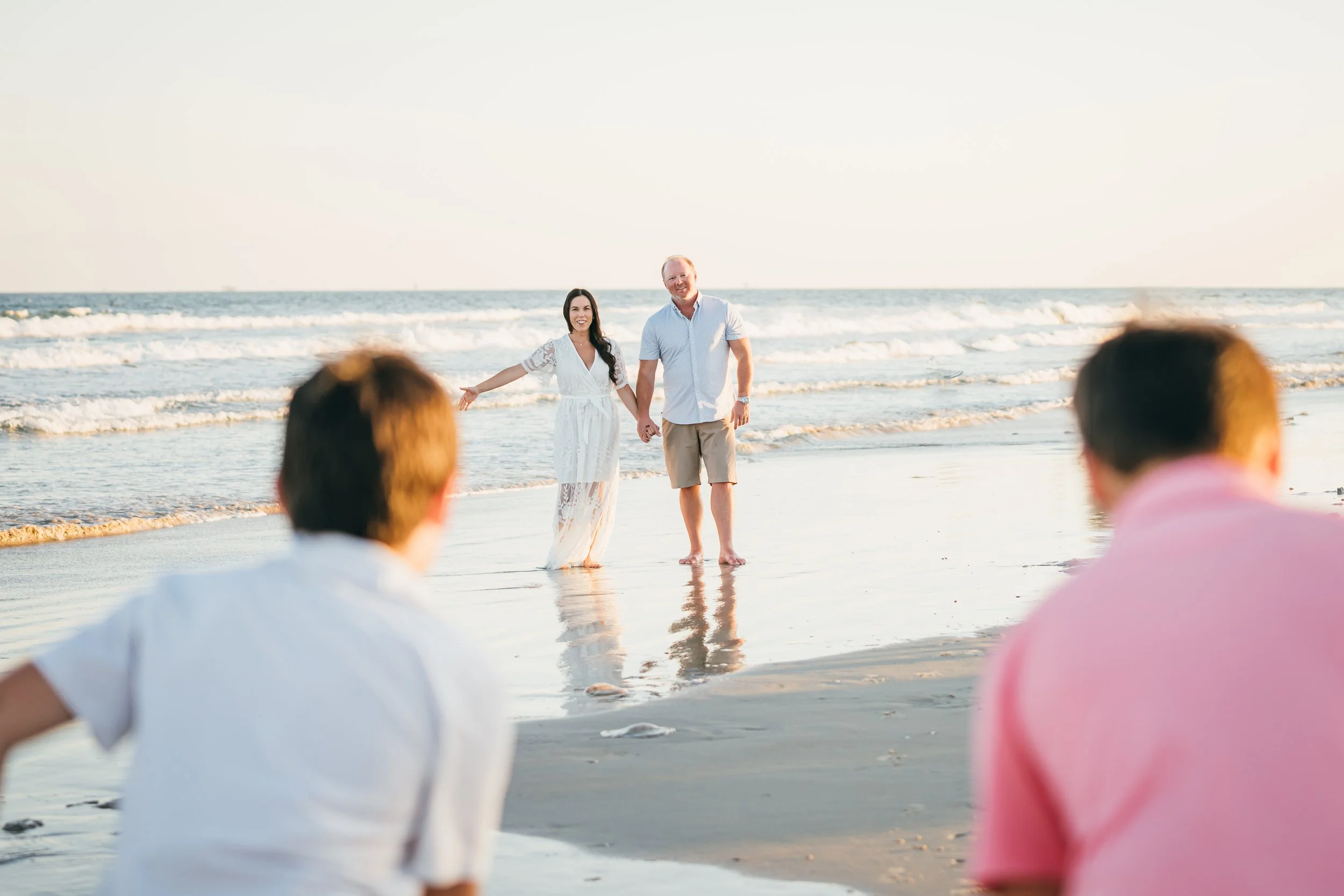 Doctor Michelle and Justin Parker being at the ocean in Texas with their family for wellness experience from Aledo, Texas
