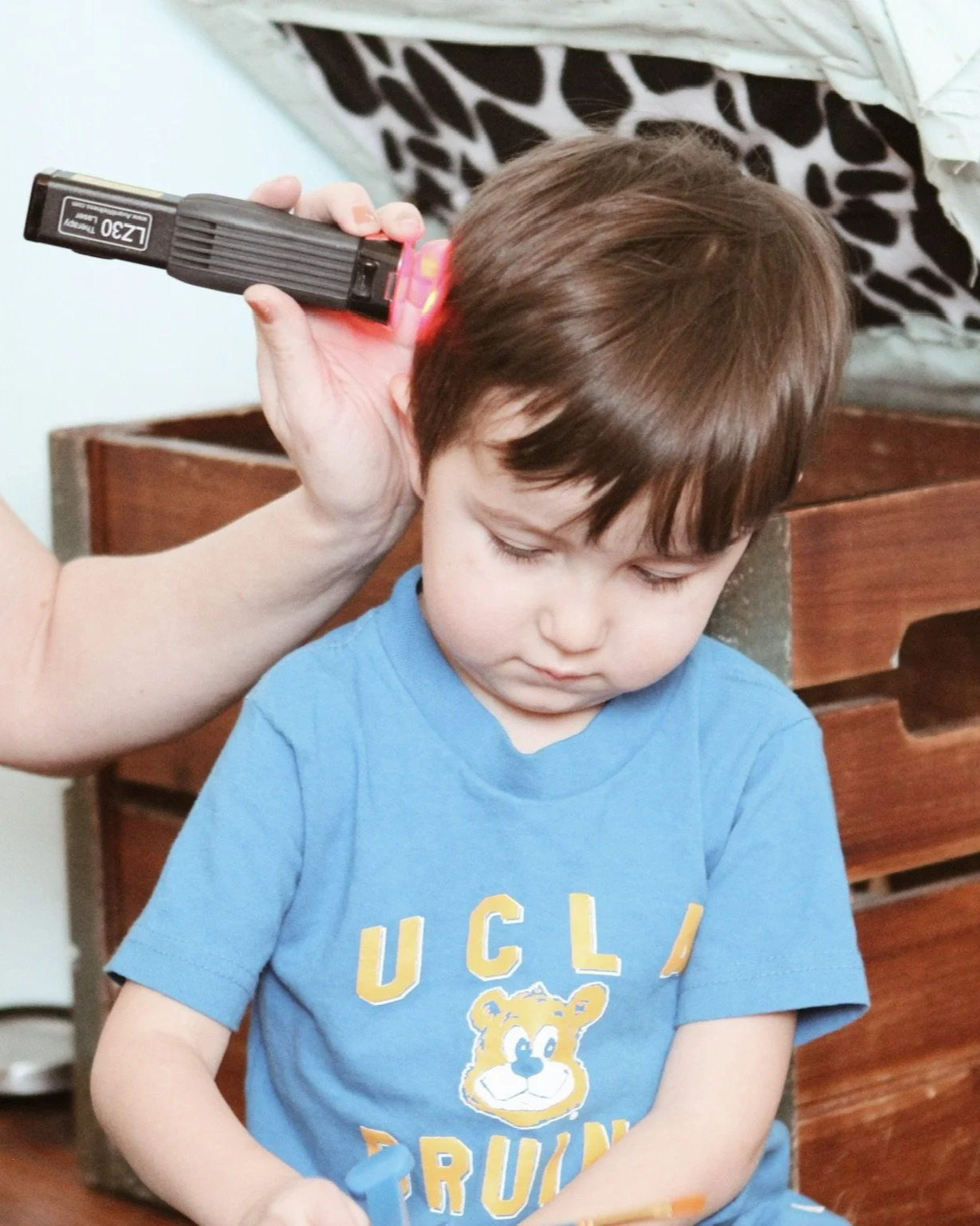 Vagus Nerve Support on child using cold laser at The Chiropractic Place for Mommy and Me in Aledo, Texas