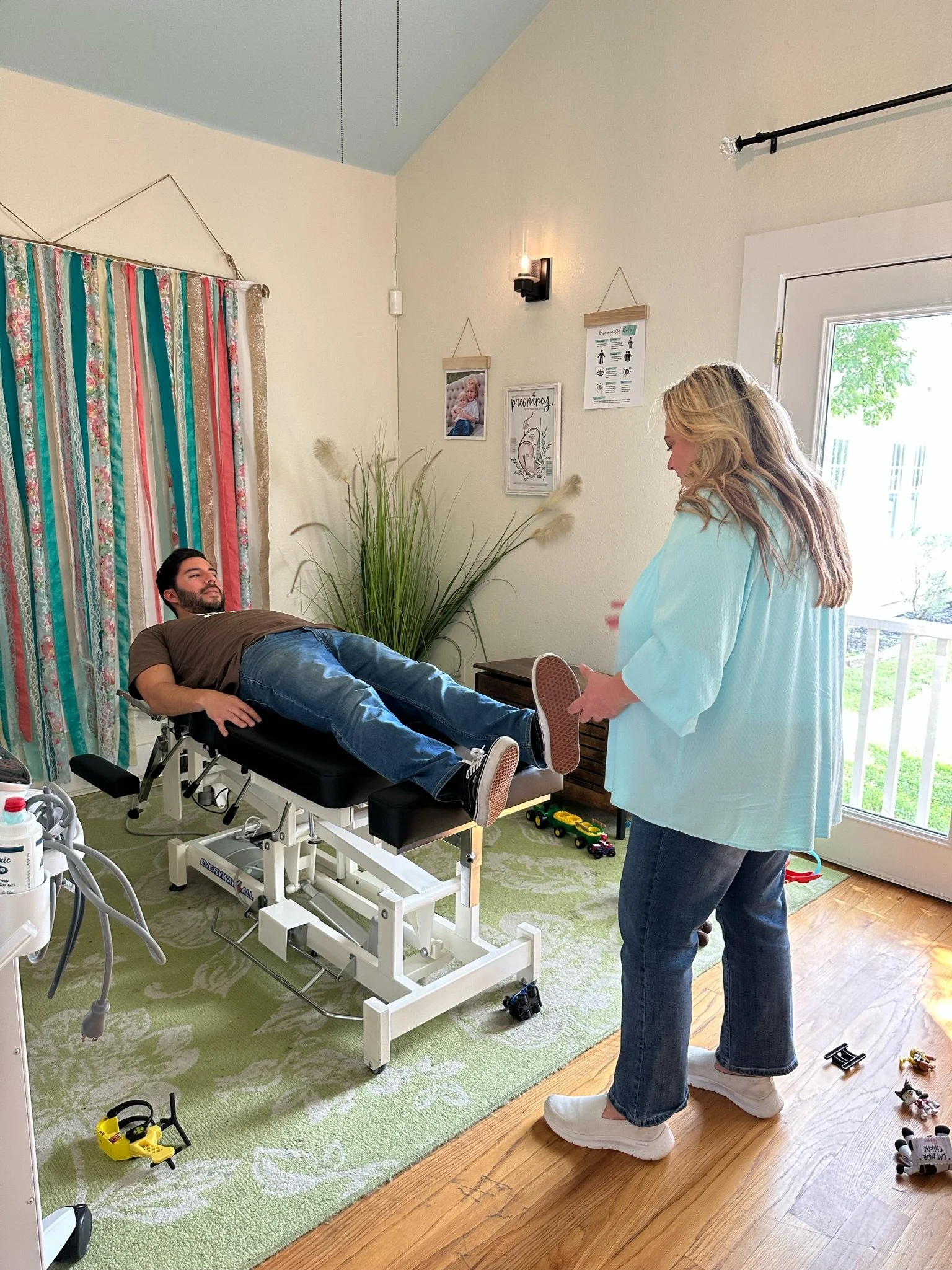 Dr Leslie Hasbini performing Injury Recall Technique with her family chiropractic adjustment at The Chiropractic Place for Mommy and Me in Aledo, Texas
