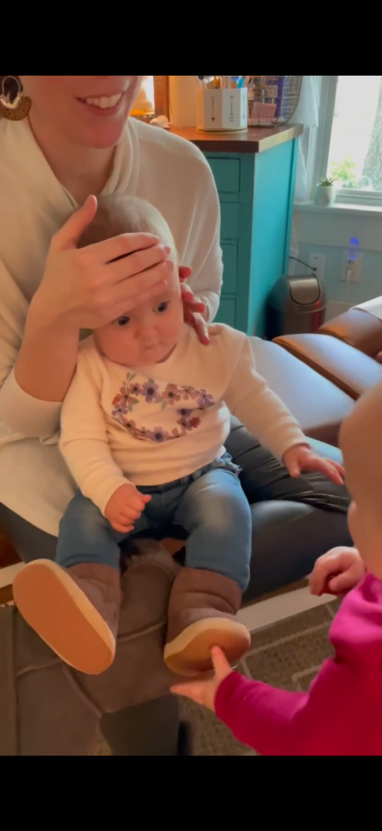 Dr Michelle Parker with performing pediatric chiropractic with twins at The Chiropractic Place for Mommy and Me in Aledo, Texas