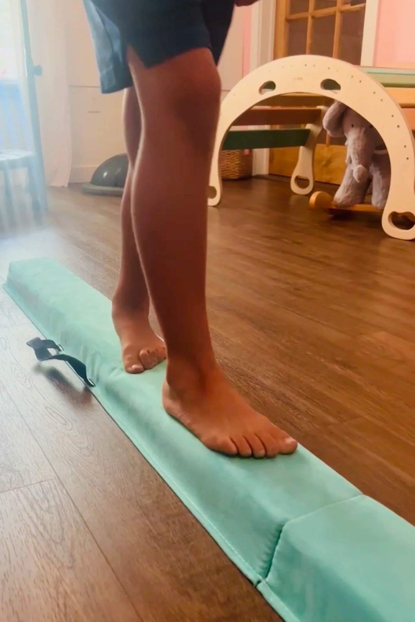 Elementary School Boy walking on balance beam for coordination for childhood development visit at The Chiropractic Place for Mommy and Me in Aledo, Texas