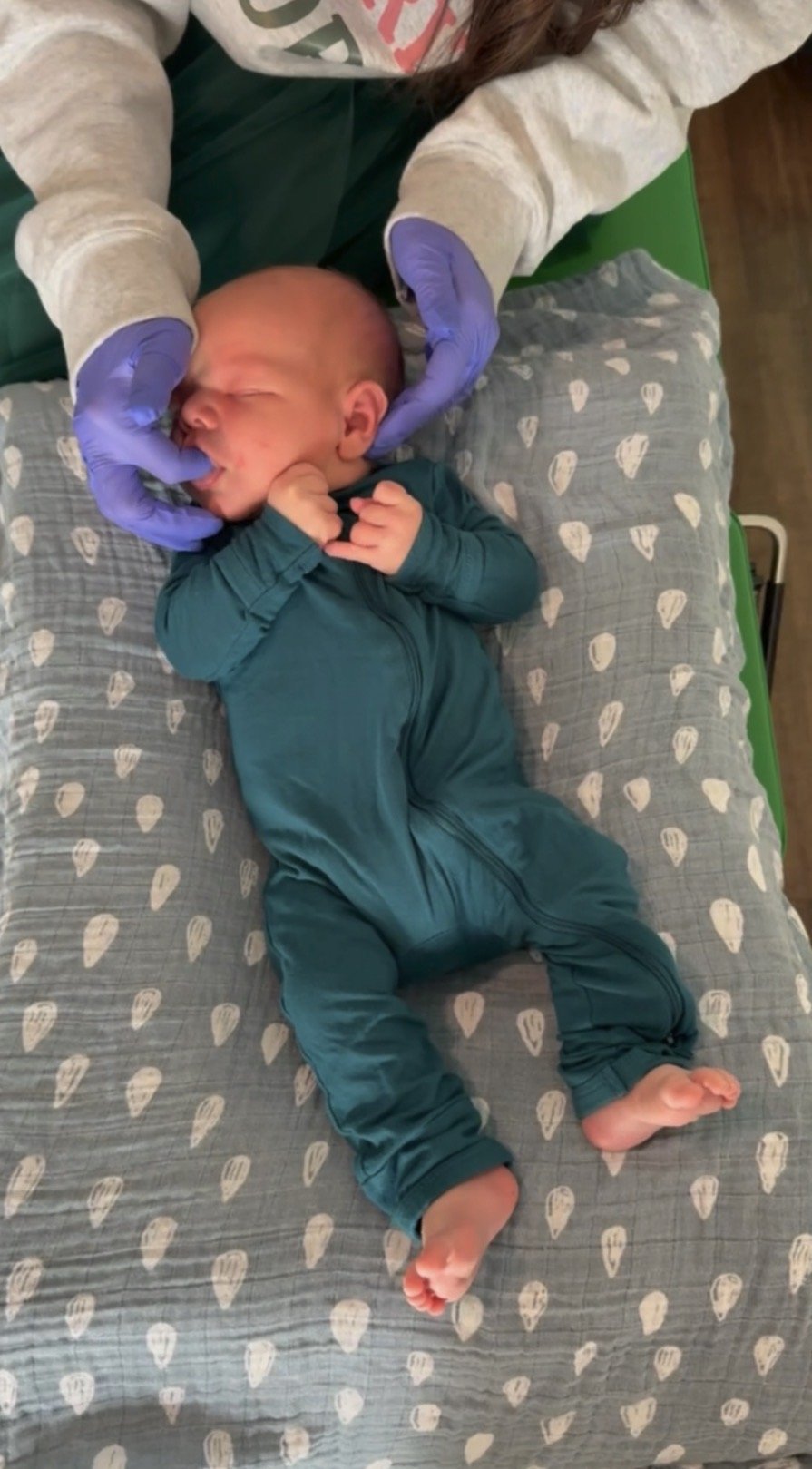 Newborn receiving first gentle, pediatric chiropractic adjustment at The Chiropractic Place for Mommy & Me in Aledo, Texas