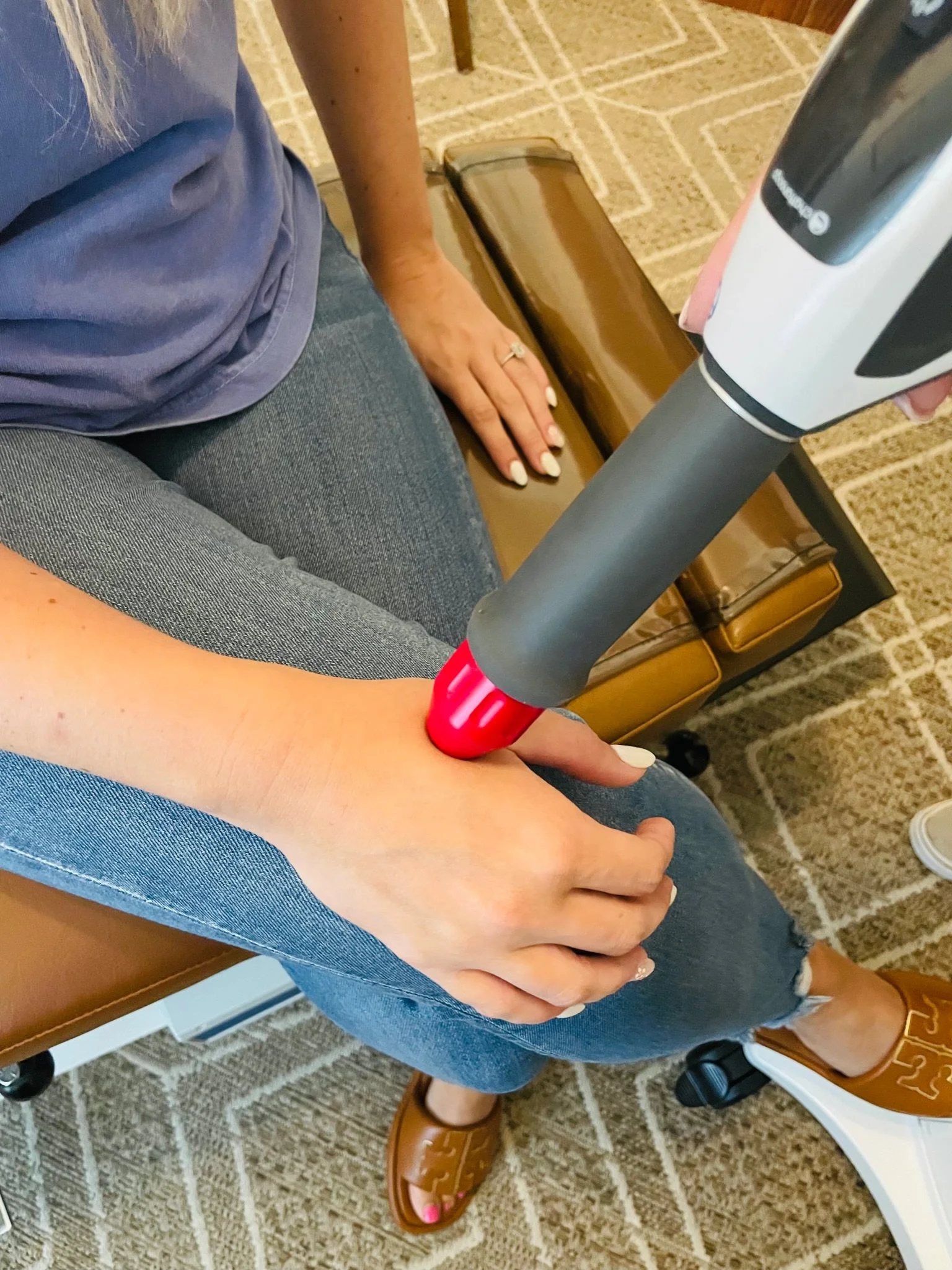 Shockwave on mommy's thumb at The Chiropractic Place for Mommy and Me in Aledo, Texas