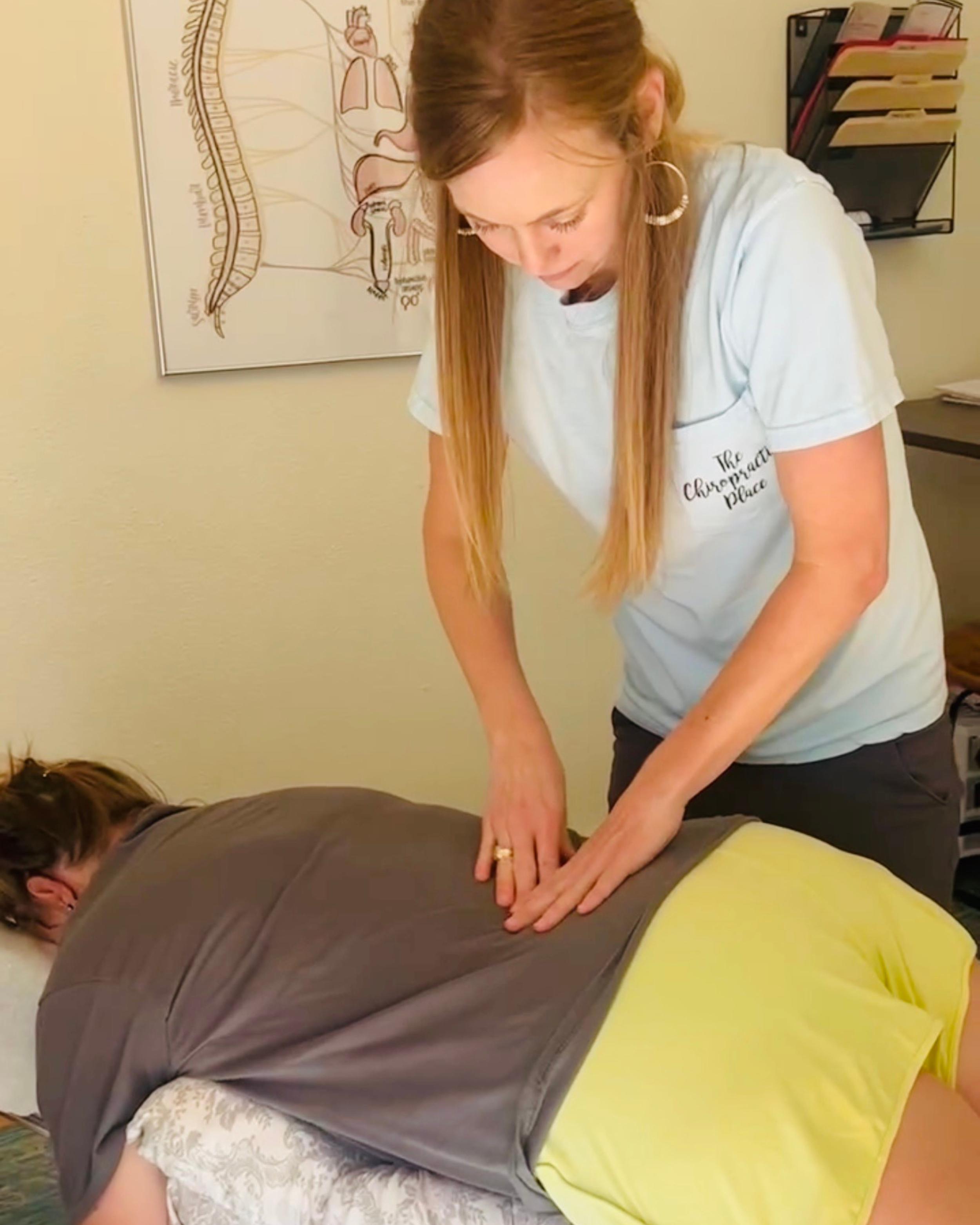 Dr Kayla Ahlfinger performing a prenatal chiropractic adjustment using Webster Technique with child at The Chiropractic Place for Mommy and Me in Aledo, Texas