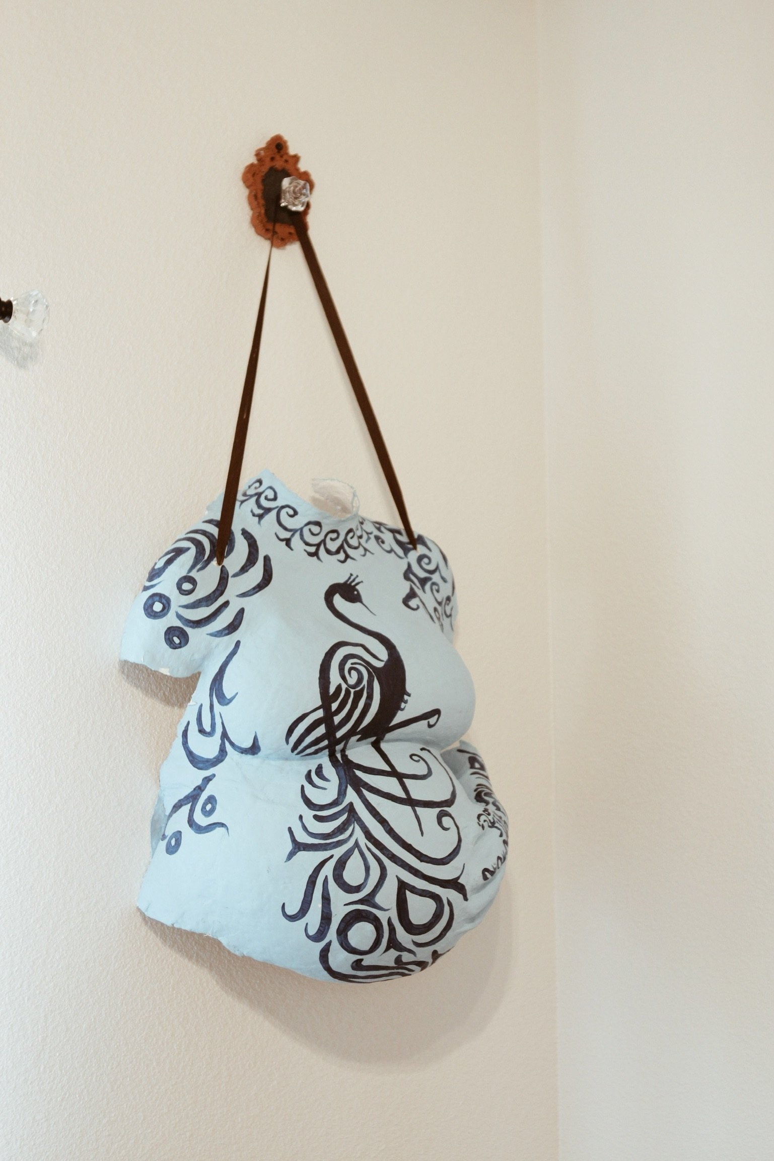 Pregnancy belly cast hanging in the prenatal massage therapy room at The Chiropractic Place for Mommy & Me in Aledo, Texas