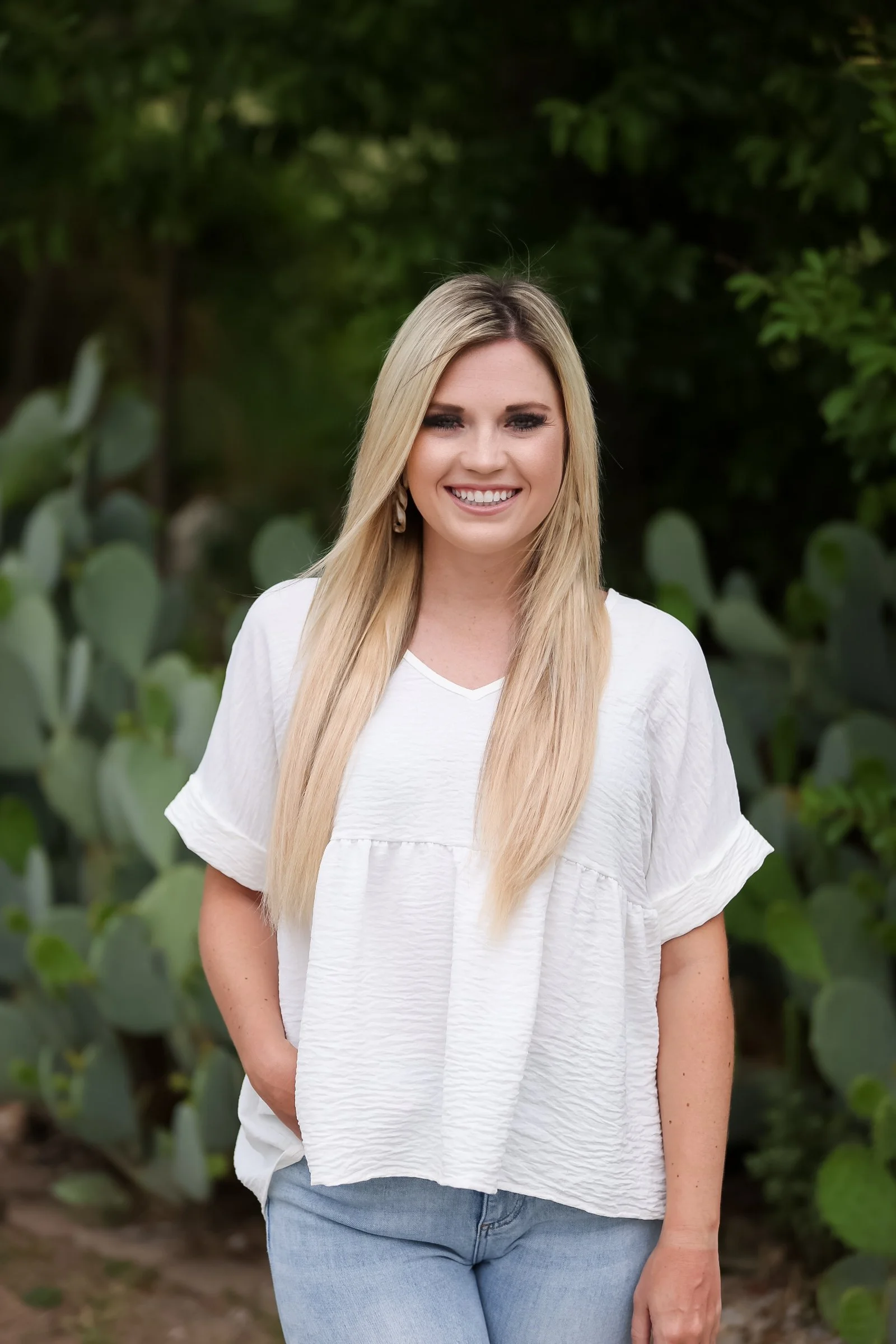 Taylor, Assistant Office Manager, standing in front of The Chiropractic Place for Mommy and Me in Aledo, Texas