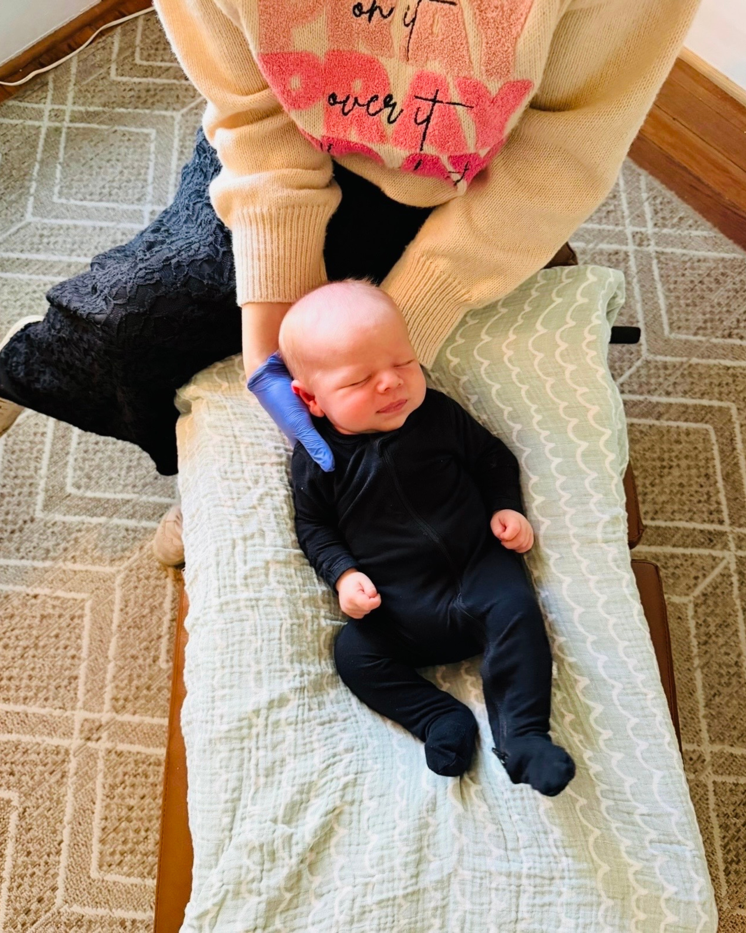 A newborn baby boy receiving craniosacral therapy and pediatric chiropractic care from Dr Michelle Parker at The Chiropractic Place for Mommy & Me in Aledo, Texas