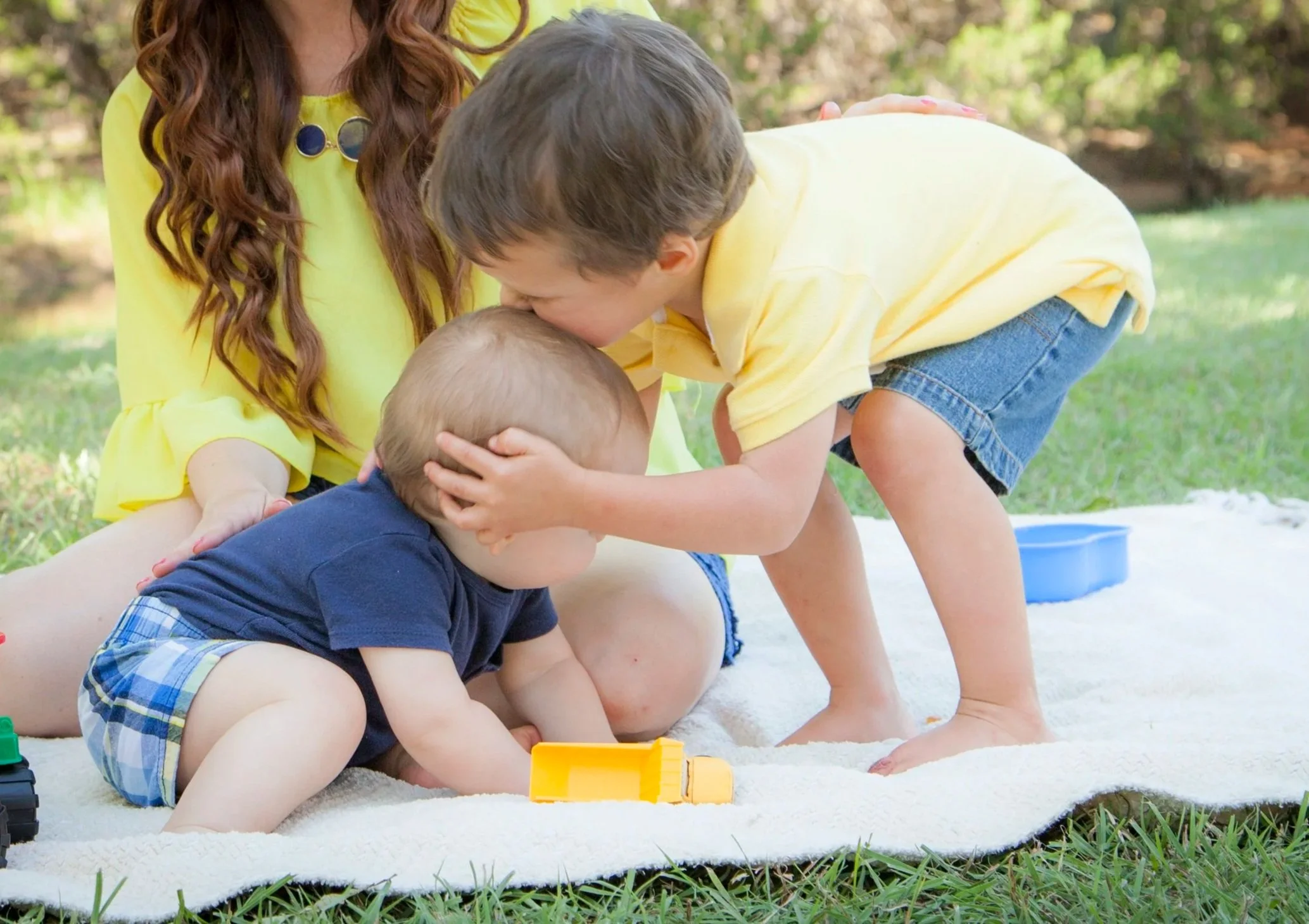 Two brothers being affectionate with each other after their pediatric chiropractic visit at The Chiropractic Place for Mommy & Me in Aledo, Texas