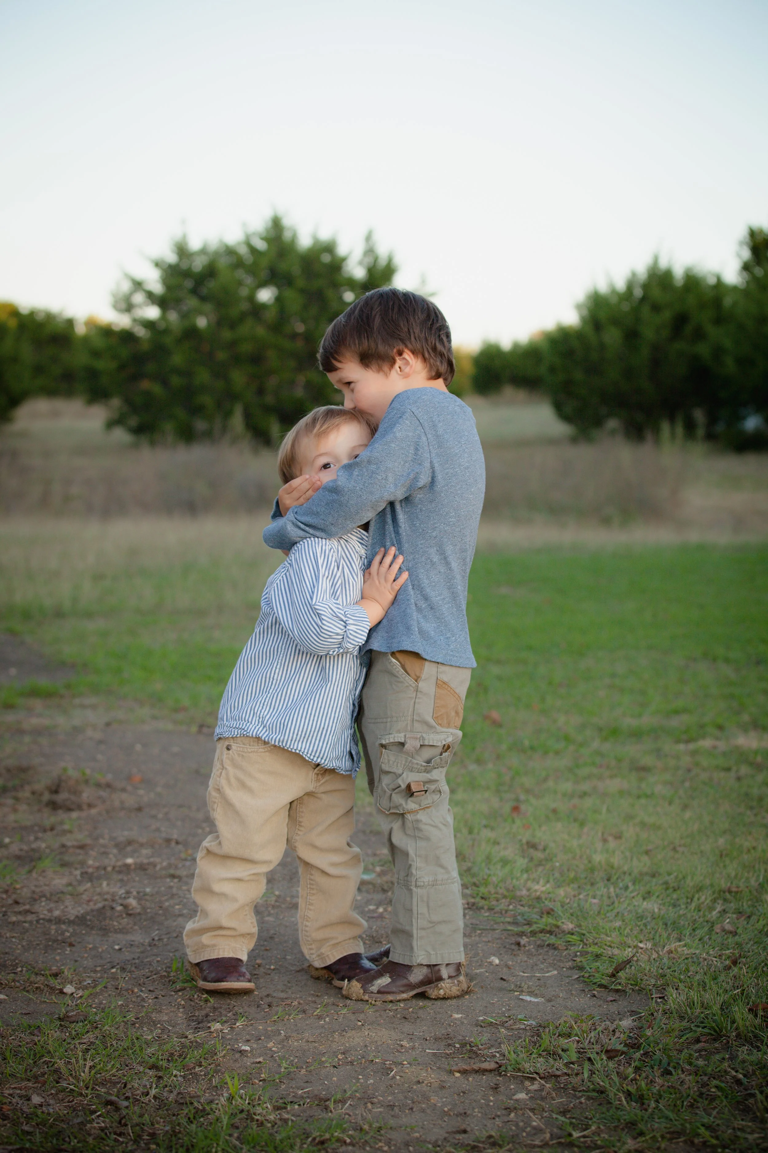 Two brothers hugging each other for nervous system regulation after being adjusted at The Chiropractic Place in Aledo, Texas