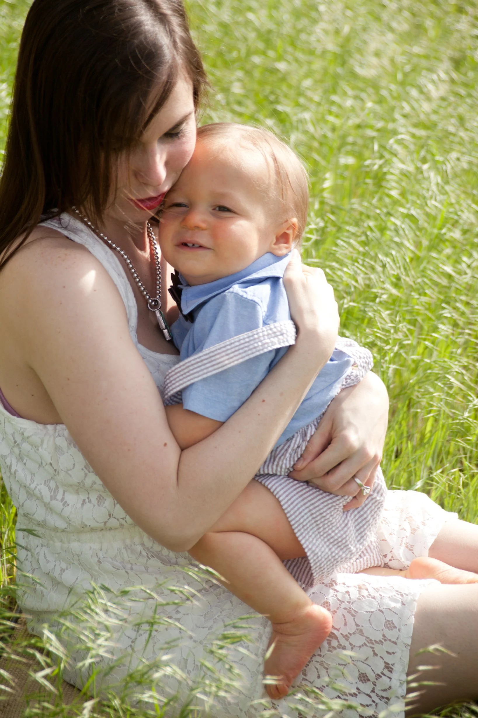 Board certified pediatric chiropractor with her toddler son in the field next to The Chiropractic Place for Mommy and Me in Aledo, Texas