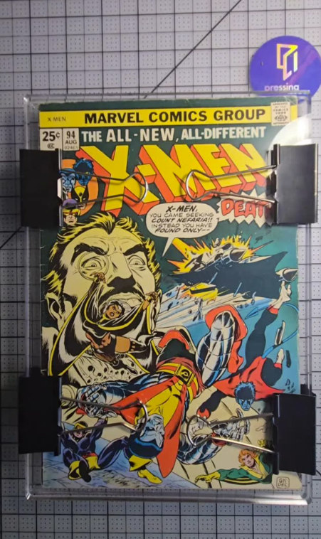 X-Men #94 comic book undergoing professional stabilization and precision pressing to improve comic book grade