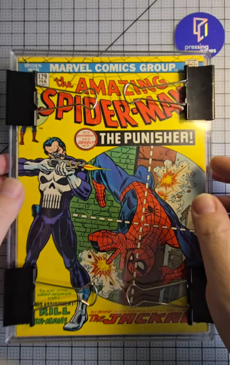 Amazing Spider-Man #129 inspected for color-breaking defects before professional comic book pressing and cleaning