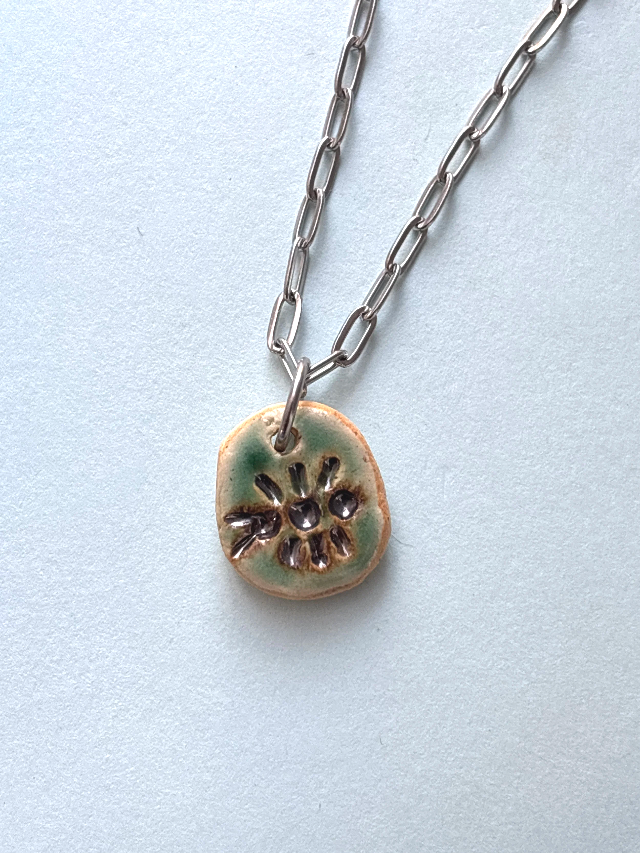 metallic bug fossil pendant (.7")