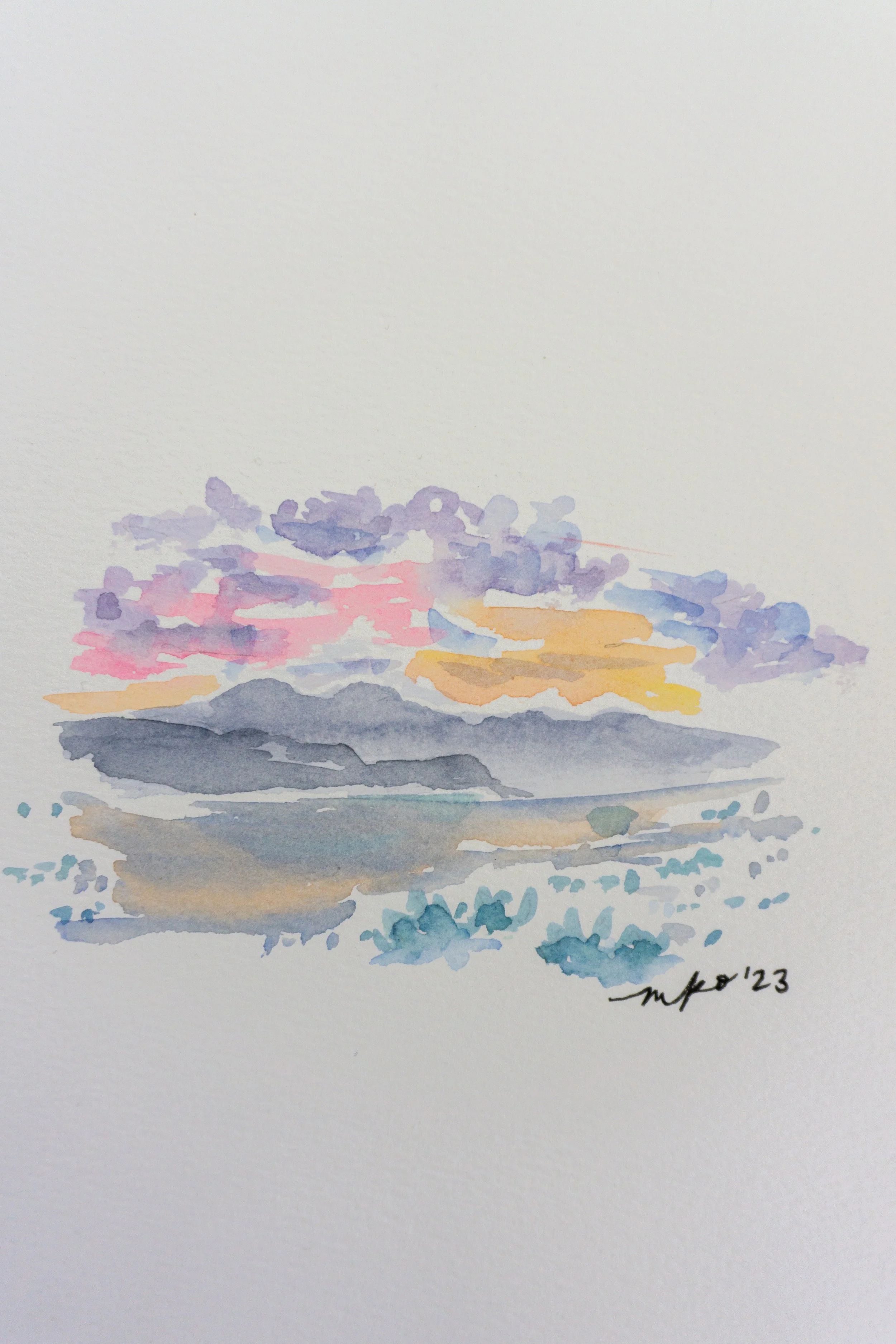 Watercolor painting of a sunset landscape with mountains and clouds in pastel colors.
