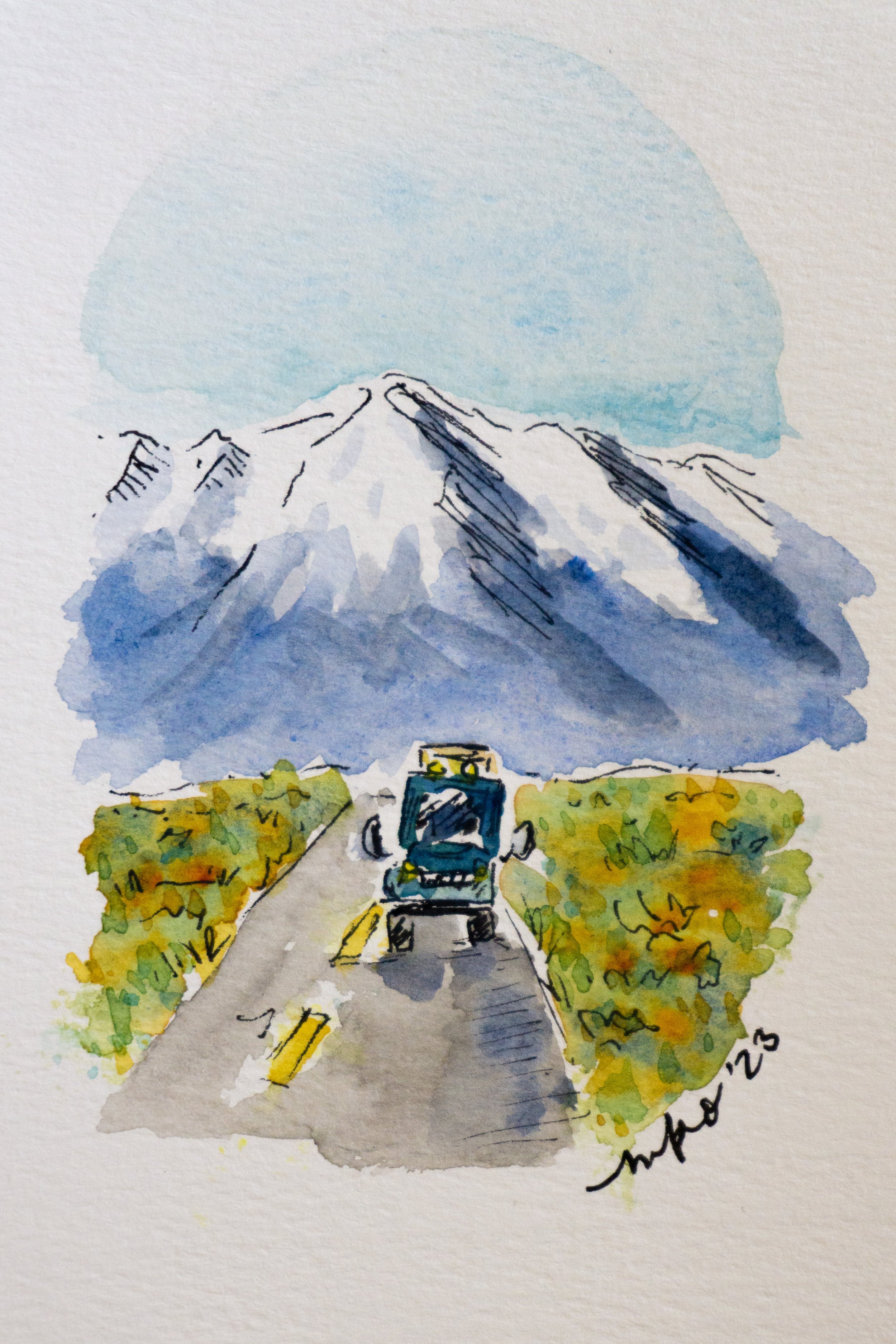 Watercolor painting of a blue truck driving down a road towards snow-capped mountains, surrounded by green and orange foliage under a blue sky.