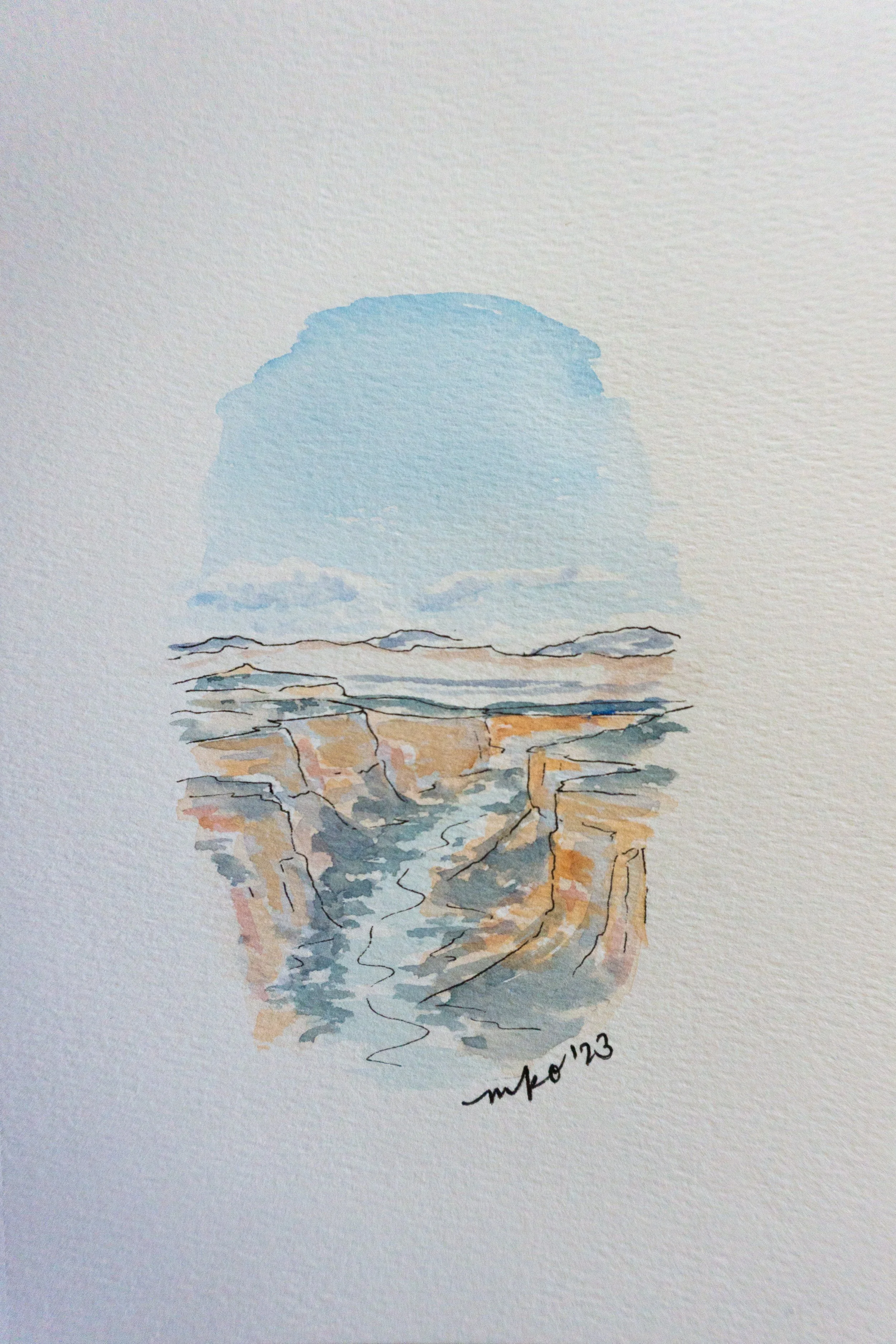 Watercolor painting of a canyon with blue sky.