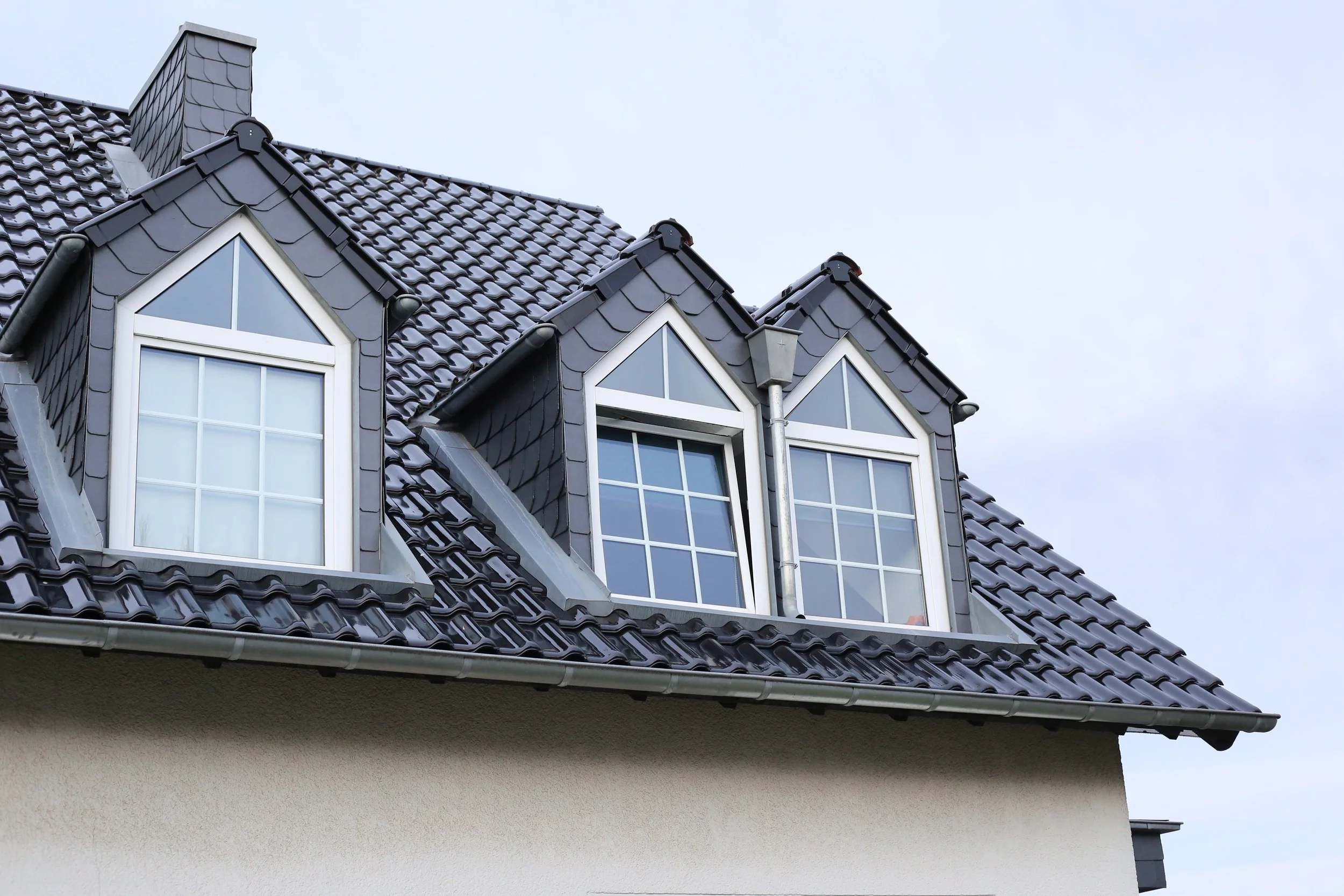 low-angle-shot-of-roof-windows-in-a-beautiful-hous-2022-12-19-08-42-35-utc.jpg