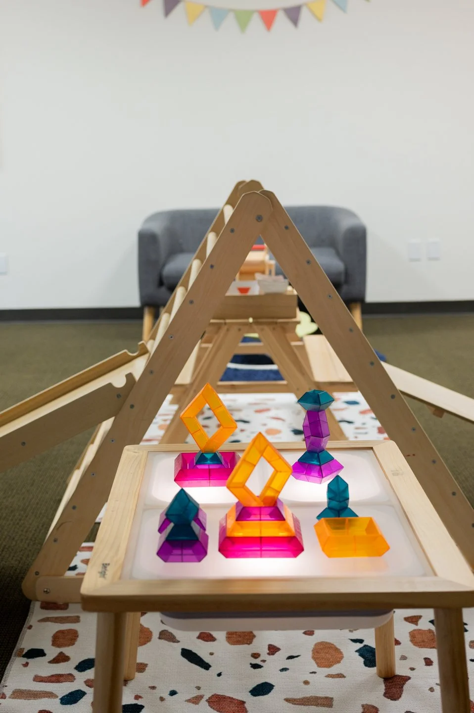 On Mondays, we switch up our sensory table with a light-up table and dim the lights in the flex space too.