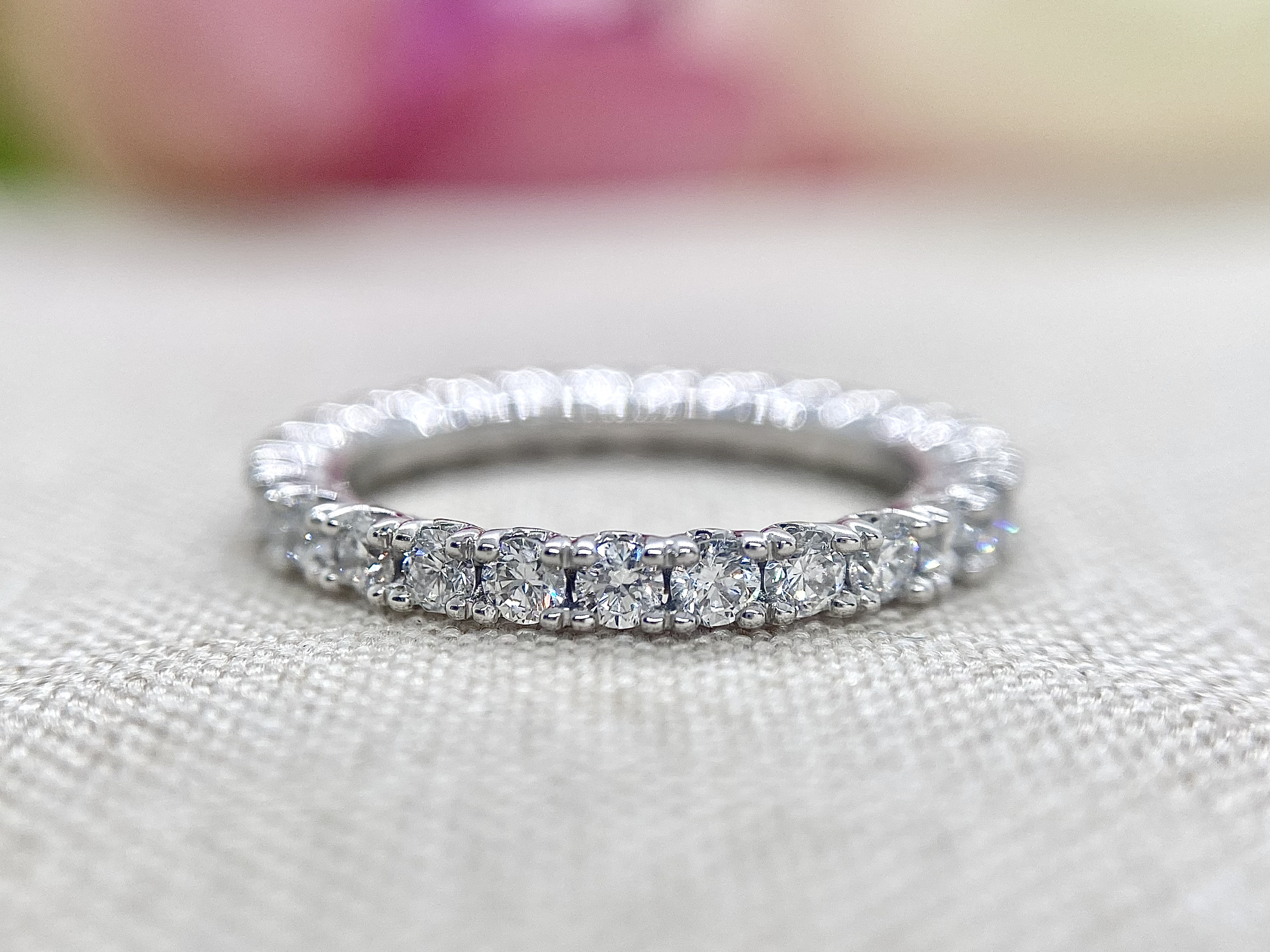 18ct white gold full circle diamond wedder featuring 9pt round brilliant cut diamonds and a tulip setting detail.