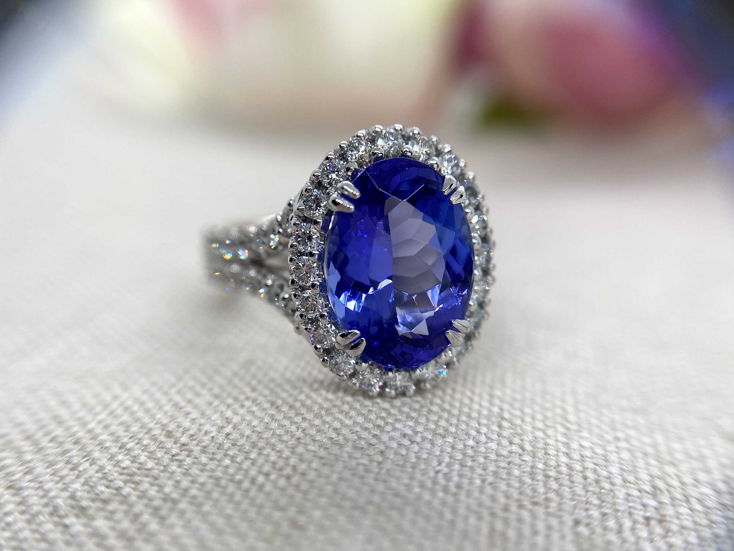 18ct white gold 4.87ct tanzanite surrounded by 1.2cts EVS round brilliant cut diamonds.