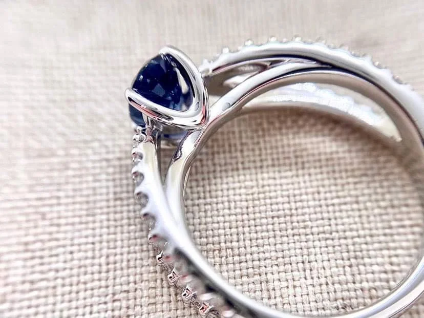 18ct white gold cocktail ring set set with an oval cut blue sapphire and 76pts of round brilliant cut diamonds.