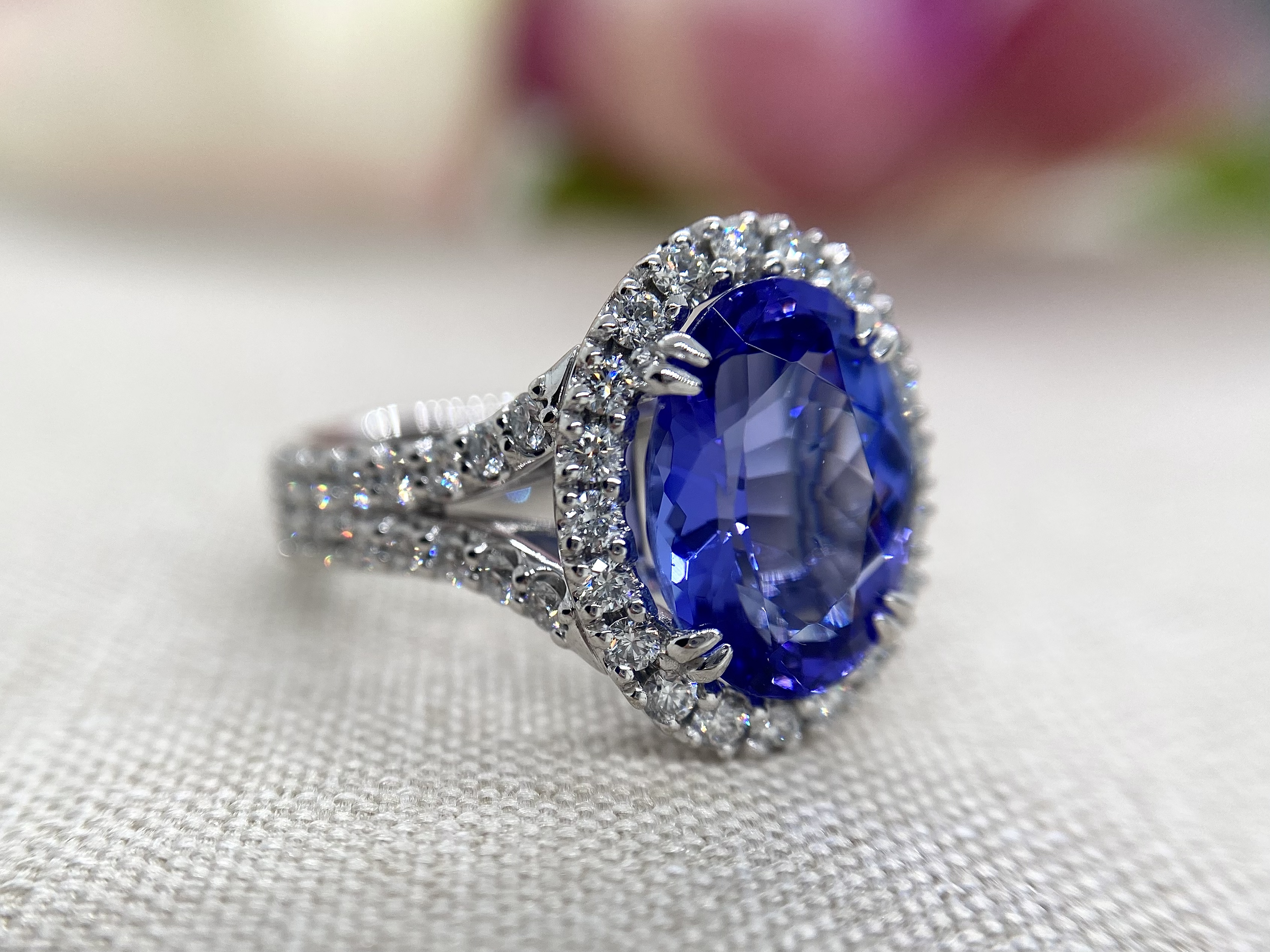 18ct white gold 4.87ct tanzanite surrounded by 1.2cts EVS round brilliant cut diamonds.