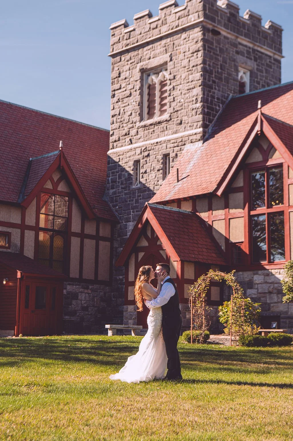 A bride and groom sharing a passionate moment during their wedding at Searles Chapel in Windham, NH. Wedding photography by Mike Indi.
