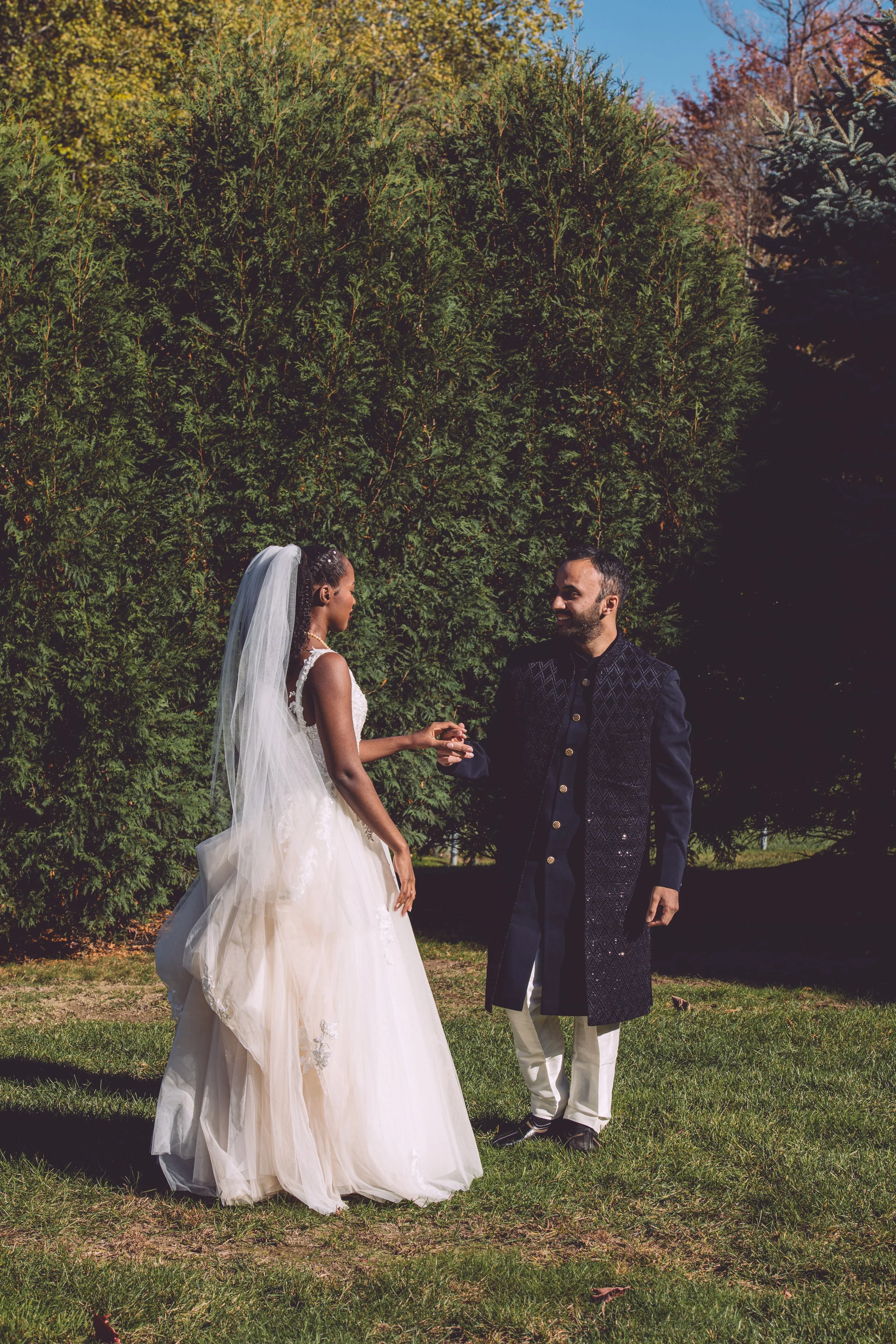 A bride and groom sharing a heartfelt and intimate moment during their first look before their wedding at Searles Chapel in Windham, NH. Wedding photography by Mike Indi.