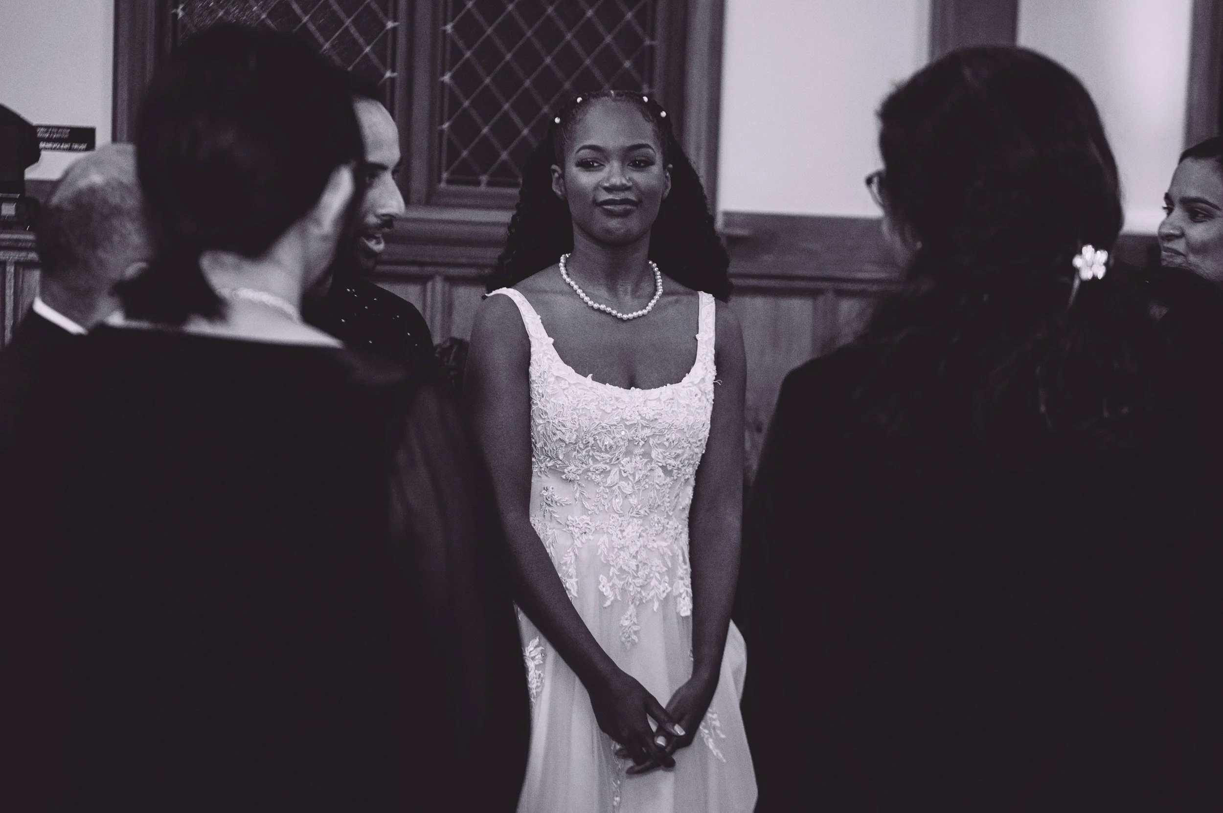 A bride and groom being surrounded by their wedding guests during their reception at Searles Chapel in Windham, NH. Wedding photography by Mike Indi.