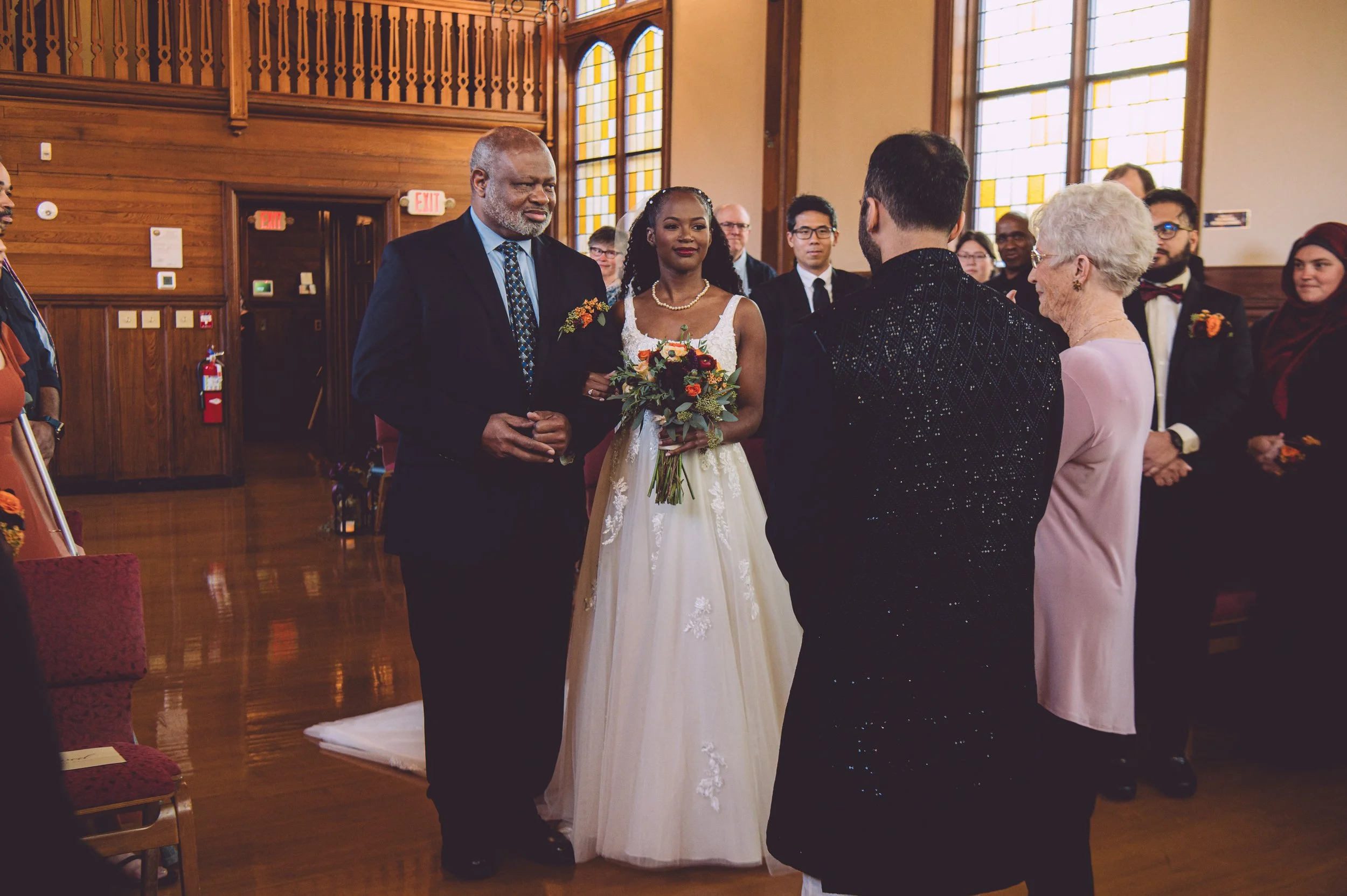 A stunning bride being presented and given away by her father during her wedding at Searles Chapel in Windham, NH. Wedding photography by Mike Indi.