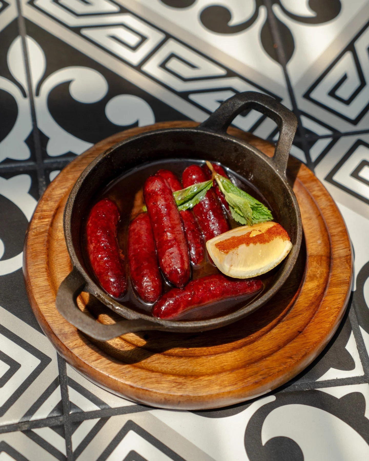 Tasty, crispy and a Mazaj favourite, try our delicious Makanek Mtafyeh.⁠
⁠
MAKANEK MTAFYEH⁠
Pan fried Lebanese sausage⁠
Pine seeds⁠
Pomegranate masalas⁠
Lemon juice