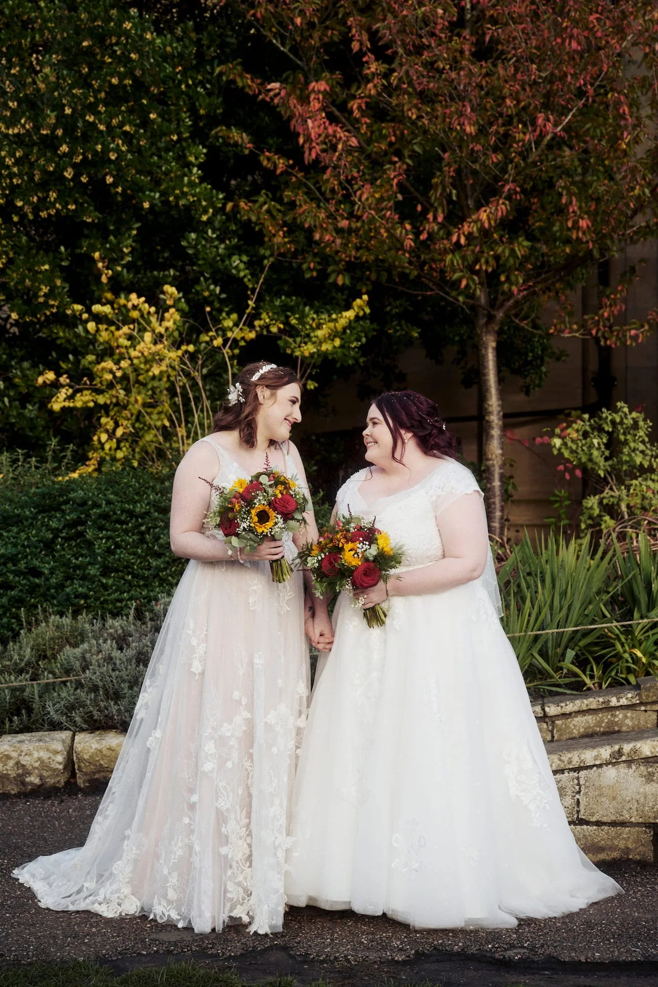 two brides holding hands